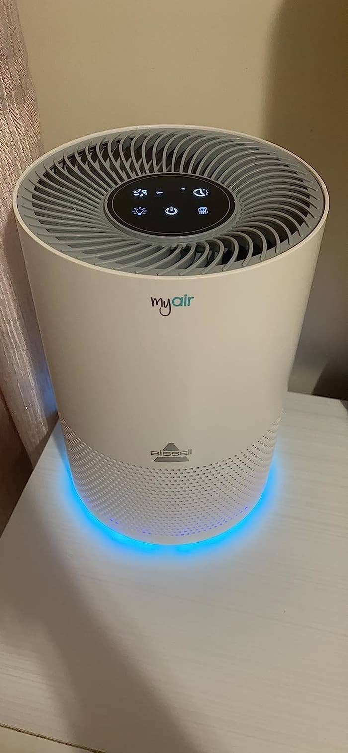 Reviewer&#x27;s air purifier with blue light glowing at bottom