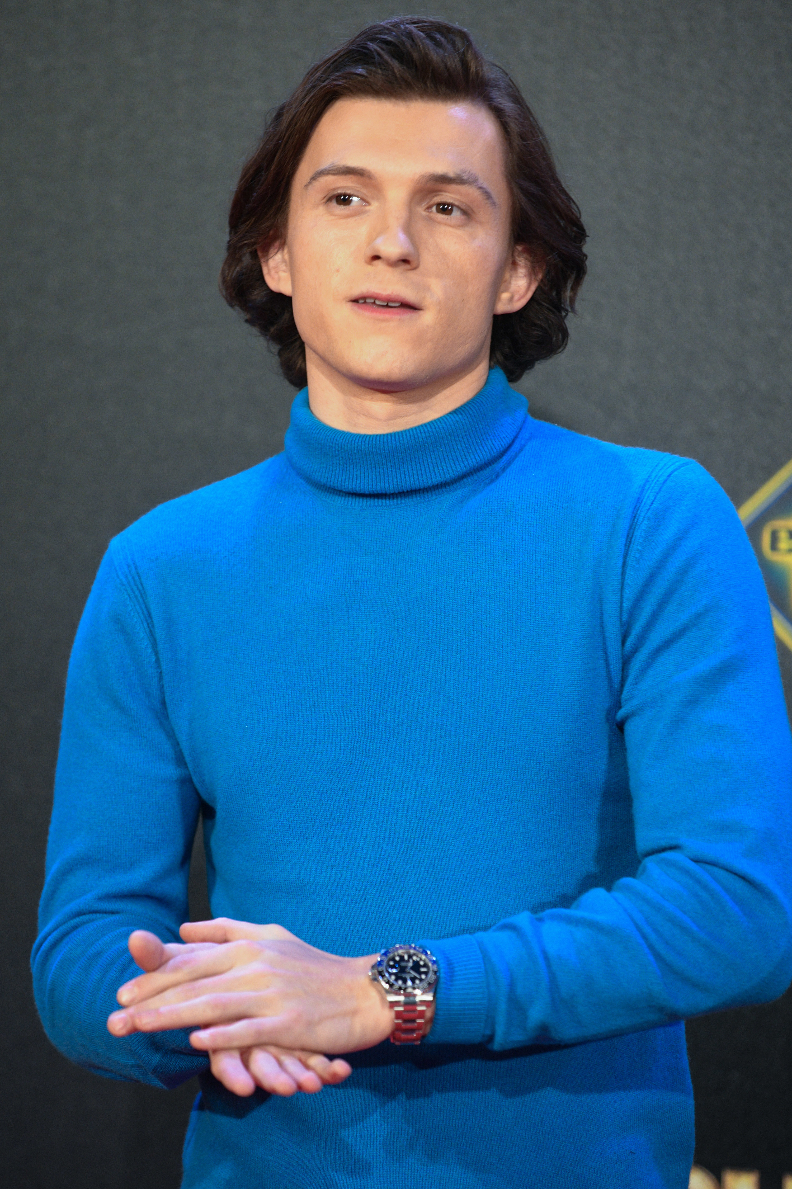 Close-up of Tom in a long-sleeved turtleneck top