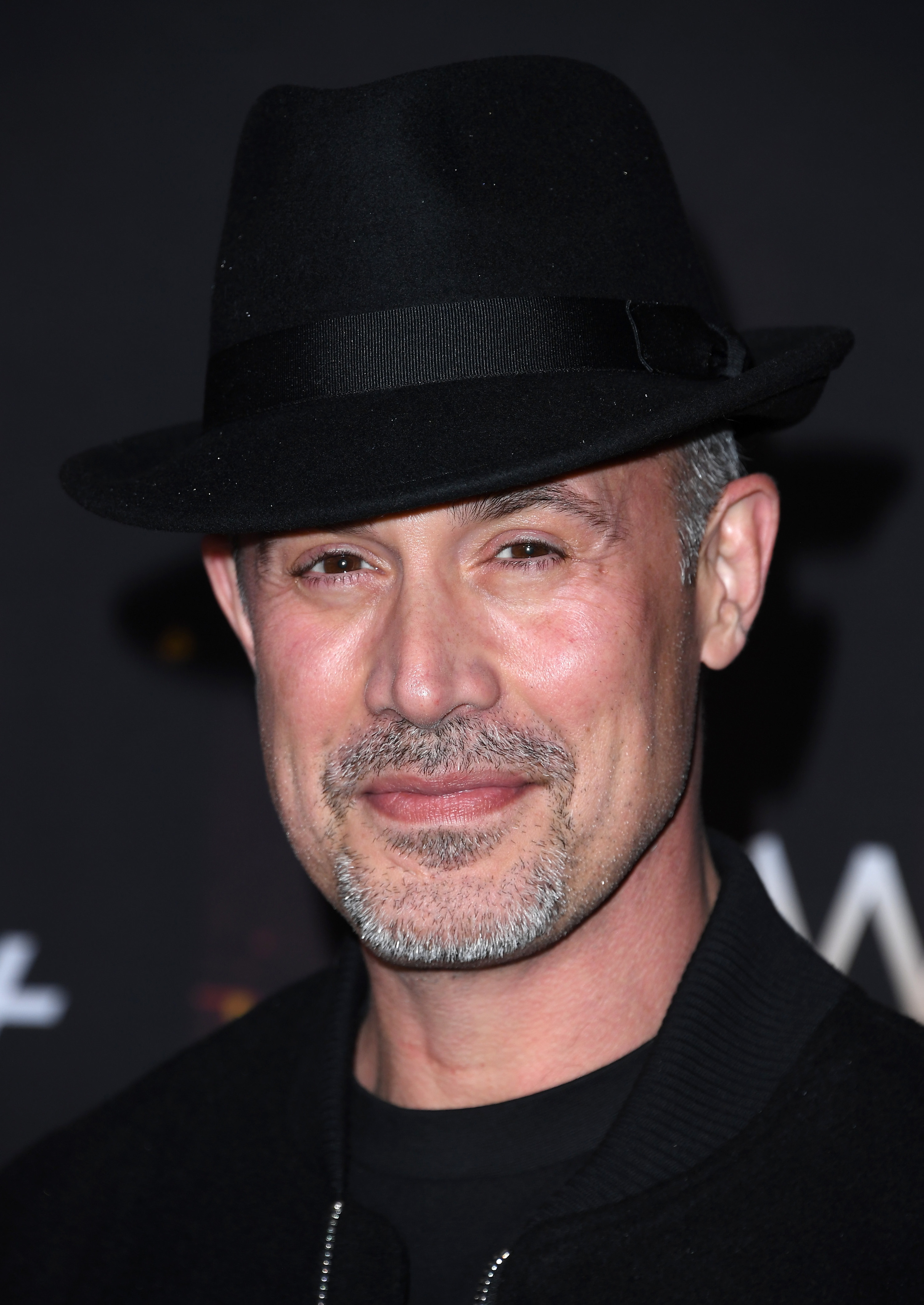 greying goatee and wearing a fedora