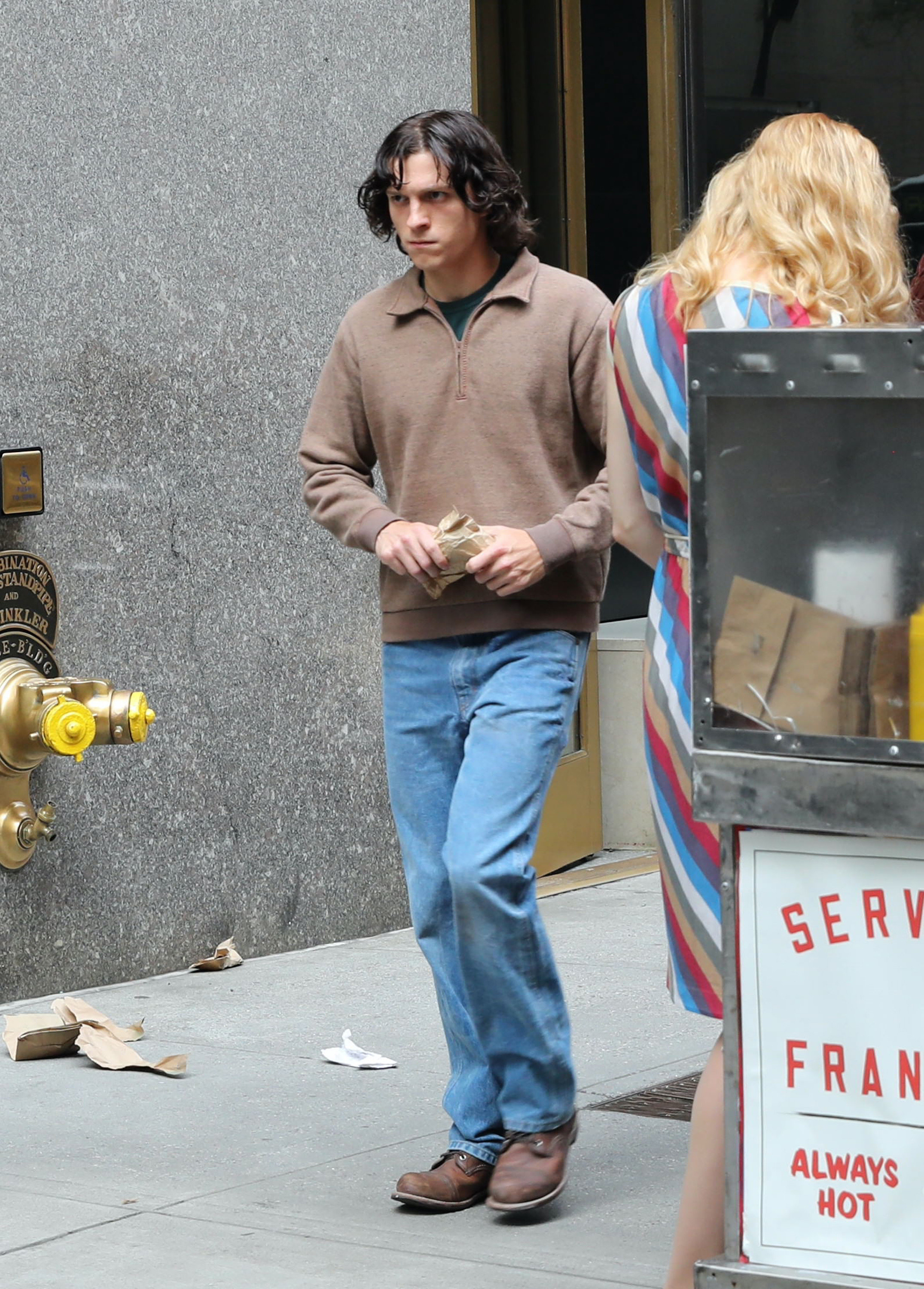 Close-up of Tom on the street in a scene from the show