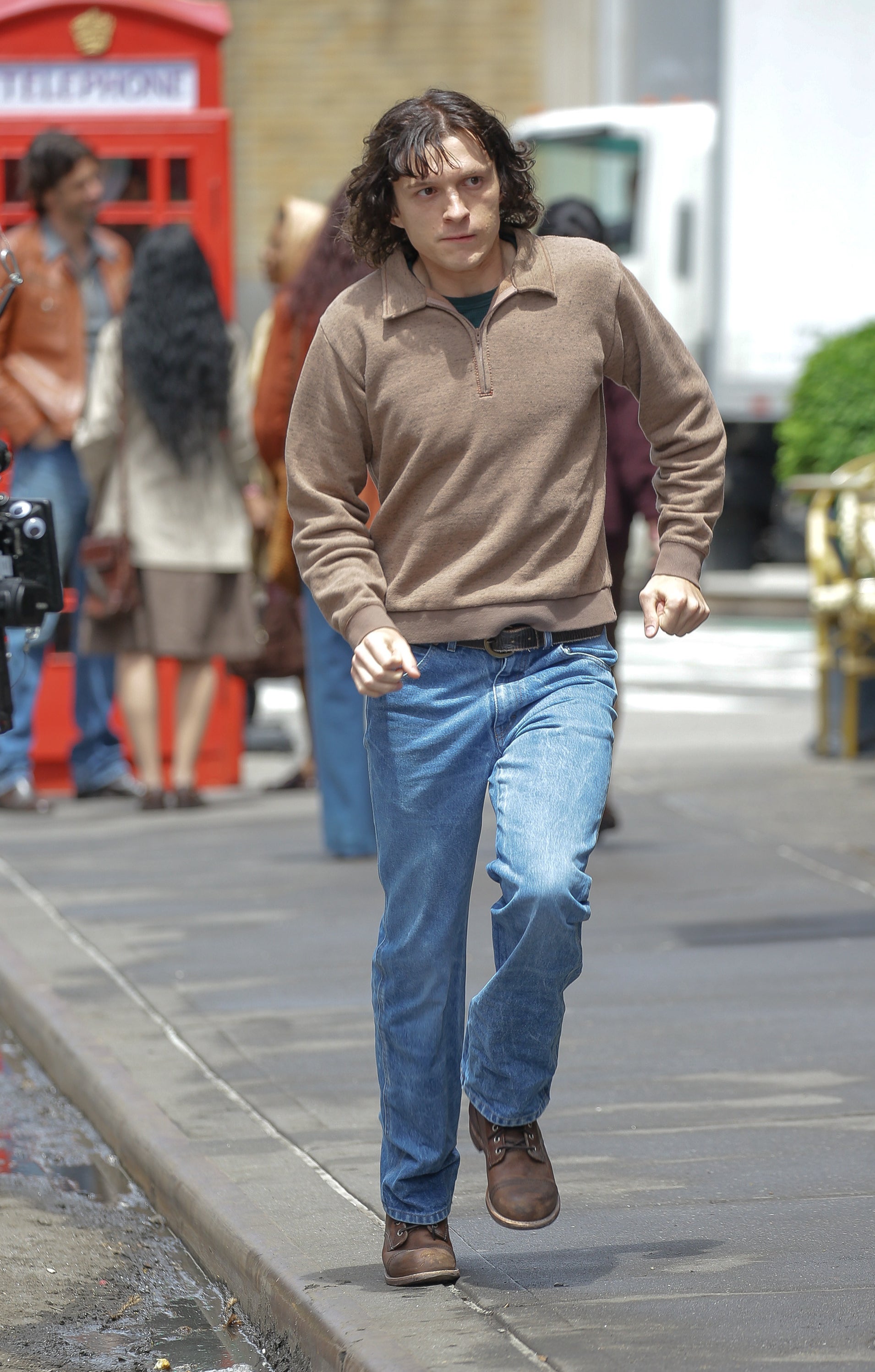 Close-up of Tom on the street in a scene from the show