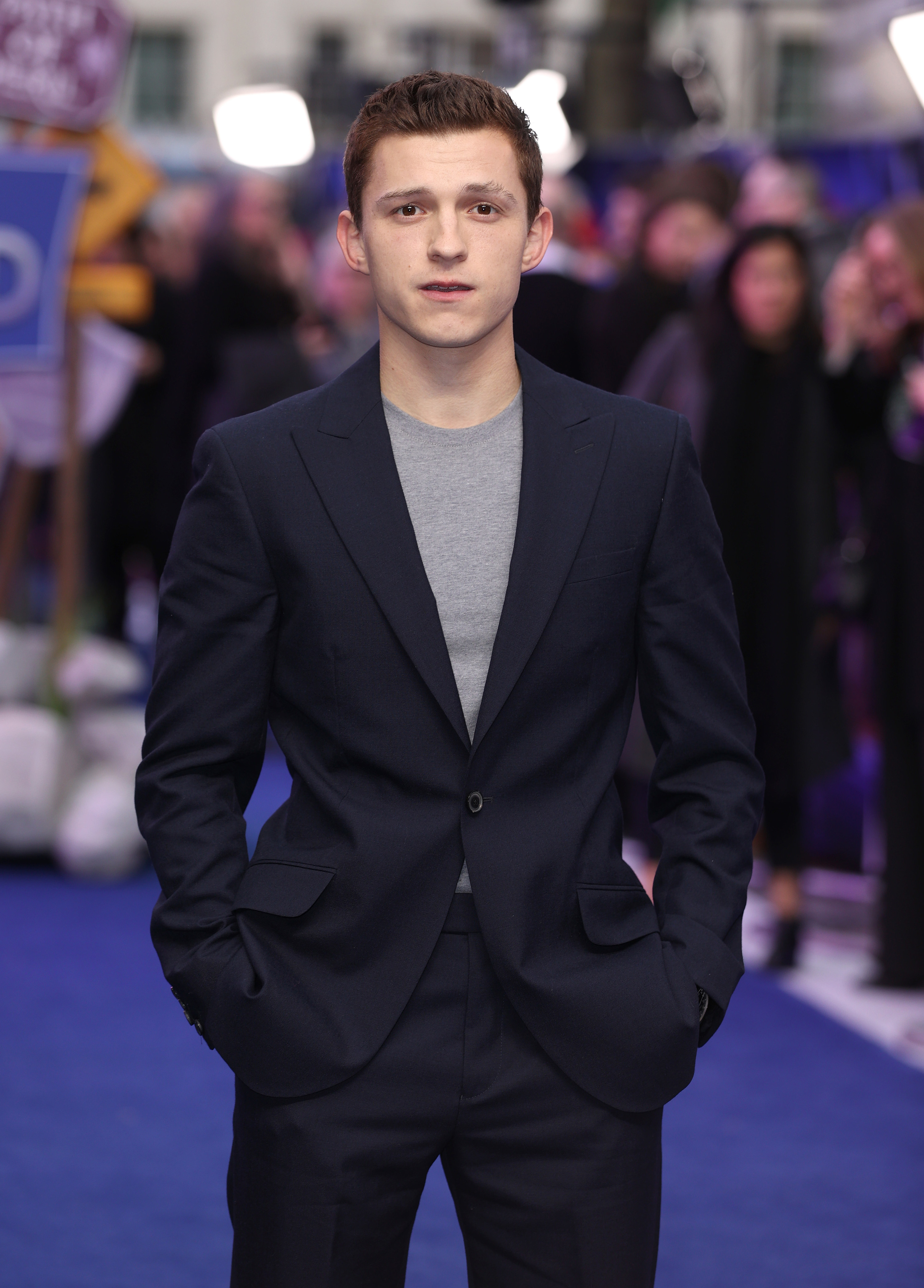 Close-up of Tom in a suit on the red carpet