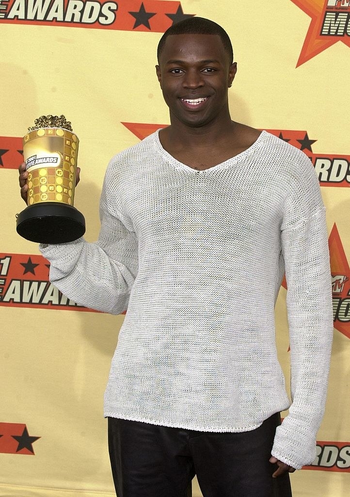 clean-shaven holding an award