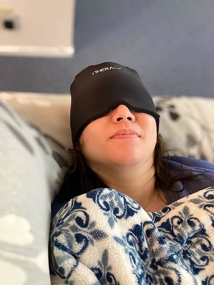 Reviewer with the wrap over eyes and head while laying down