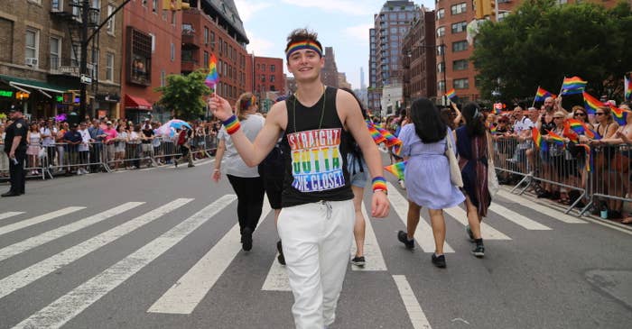 Noah Schnapp marching at Pride and wearing a &quot;Straight Outta the Closet&quot; sleeveless T-shirt