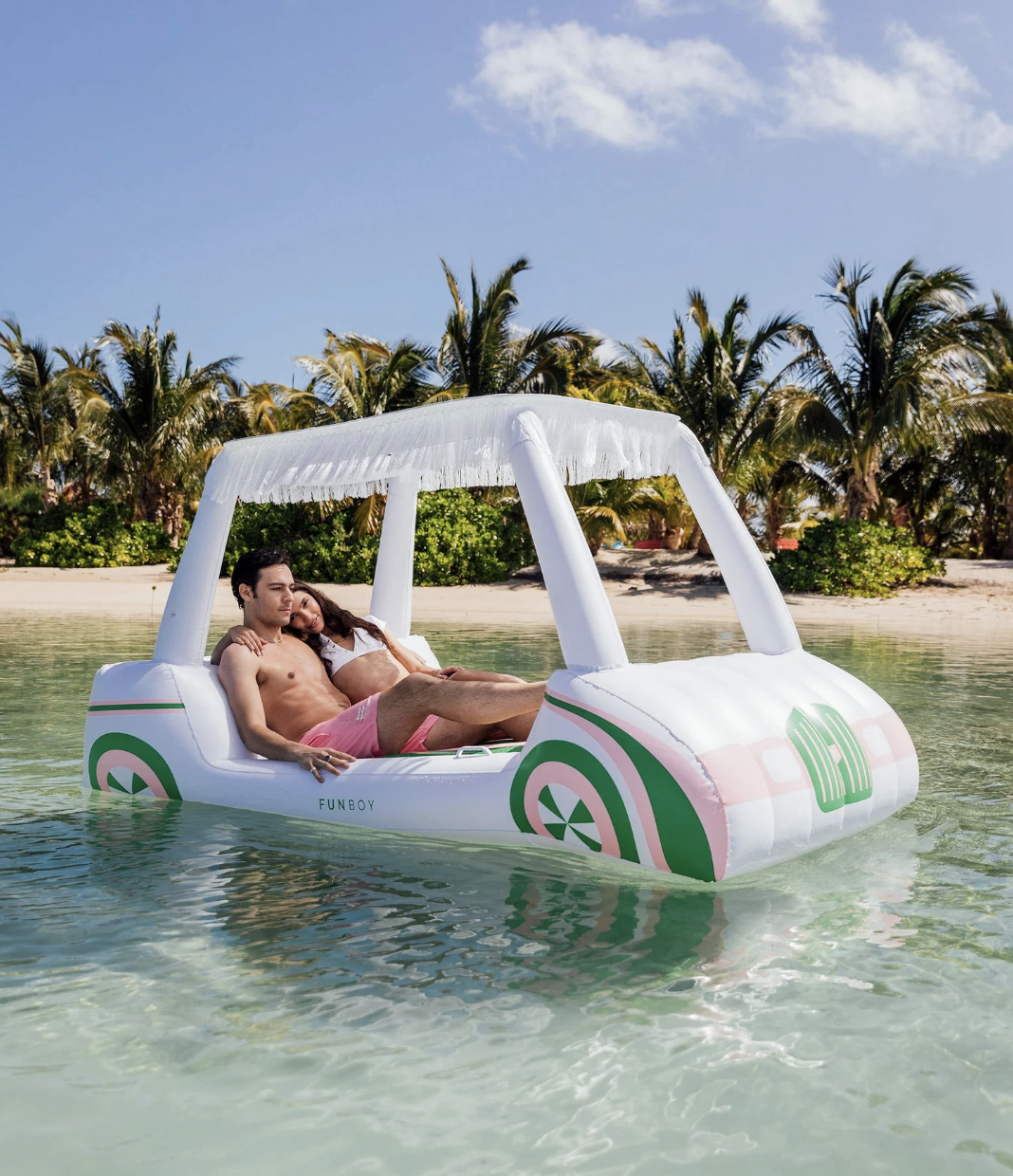 two models on green, white, and pink inflatable golf cart