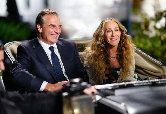 Close-up of Chris and Sarah Jessica Parker smiling and sitting together in a carriage in a scene from the show