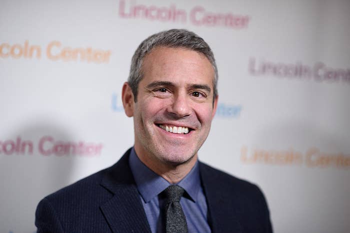 A closeup of Andy Cohen smiling on the red carpet