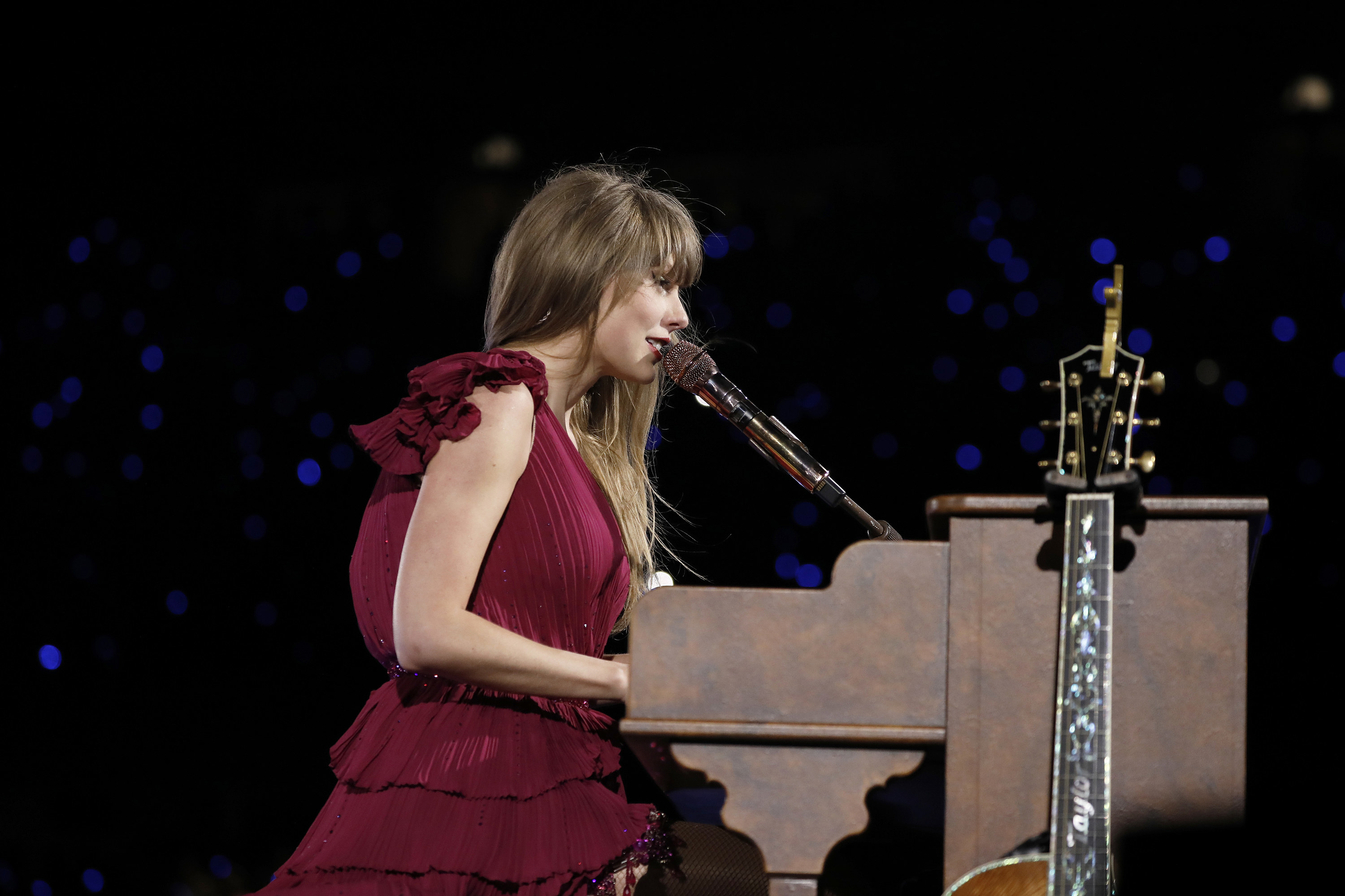 Taylor playing the piano on stage