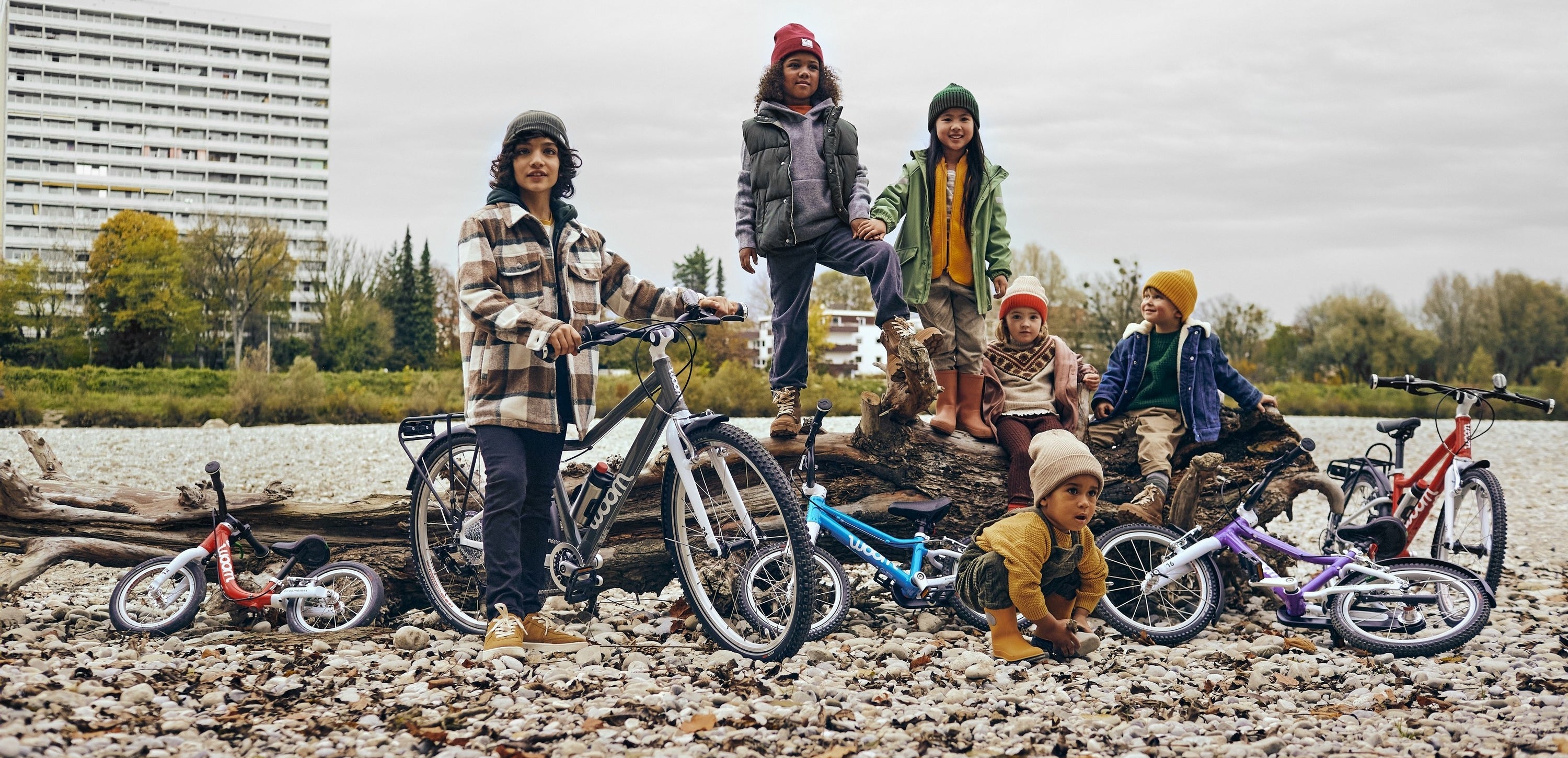 Group of child models of varying ages with varying colorful bikes