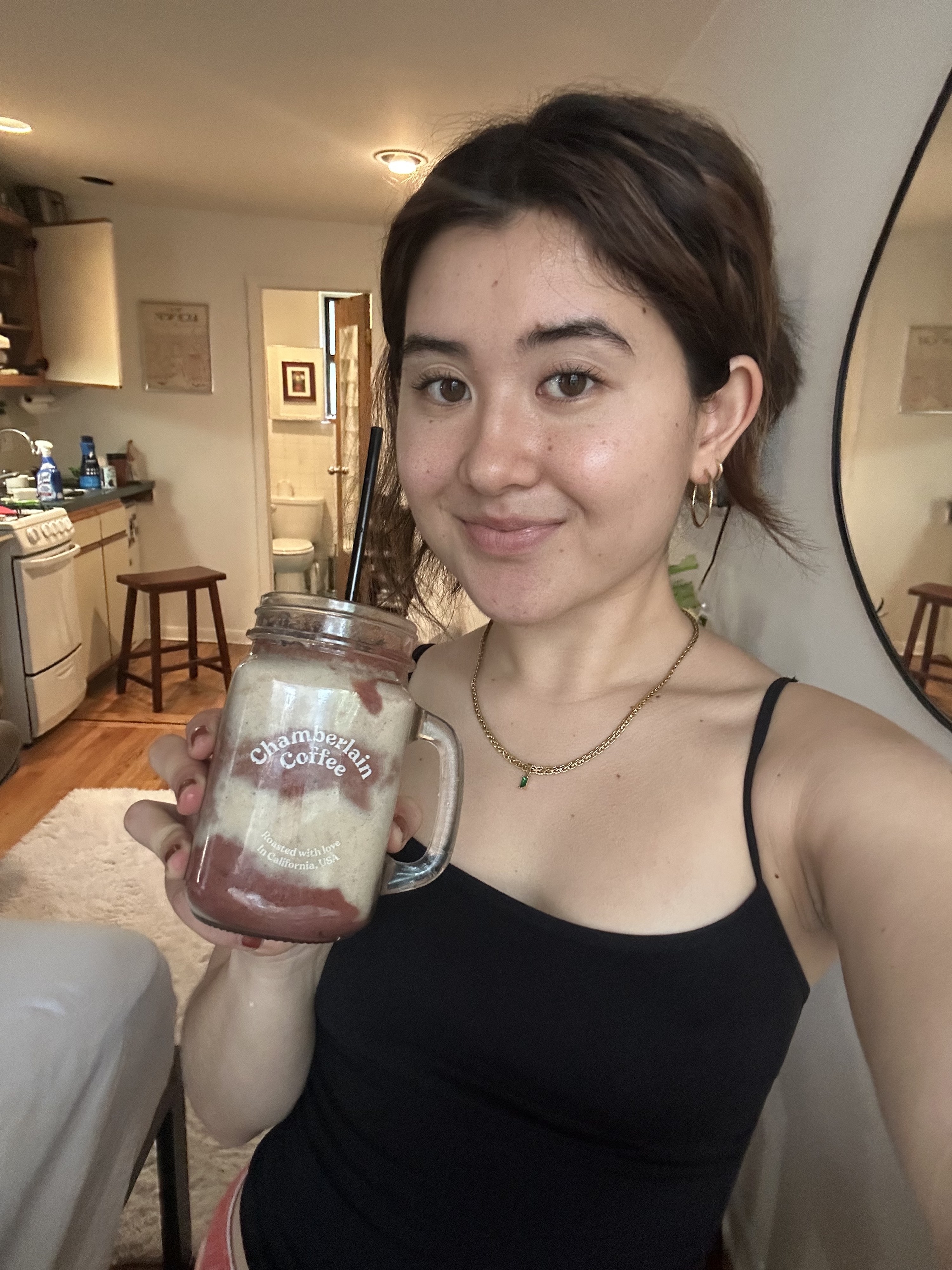 The author of the post holds the smoothie in her hand