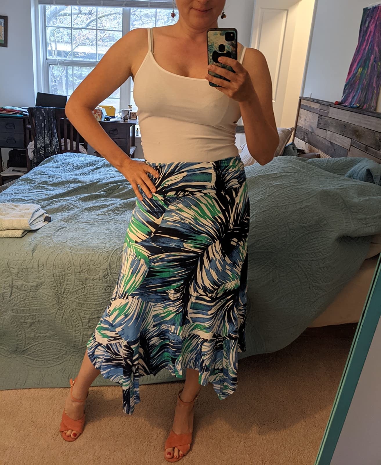 reviewer wearing the skirt in a tropical print