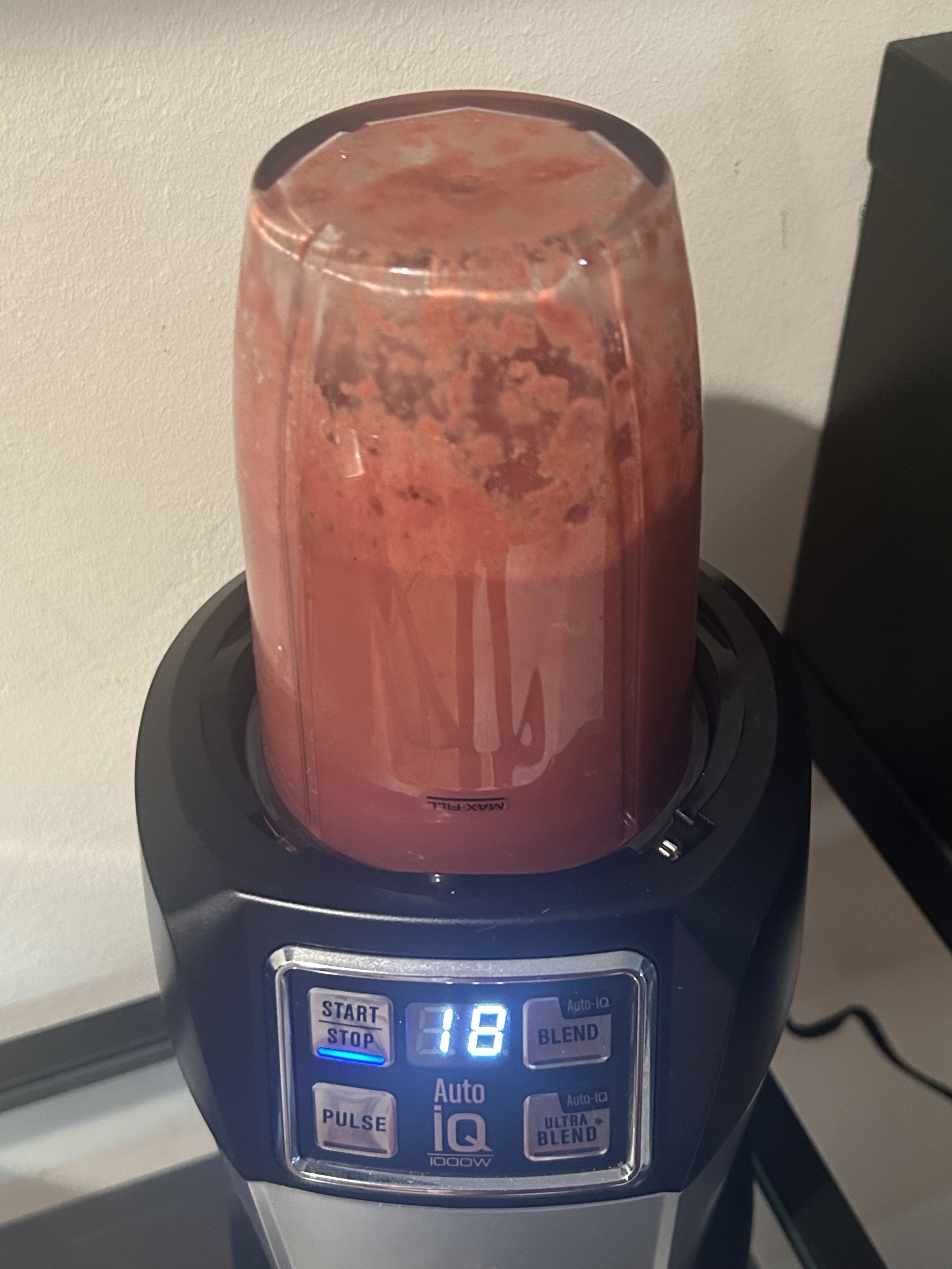 A blender is turned on and a smoothie is being made