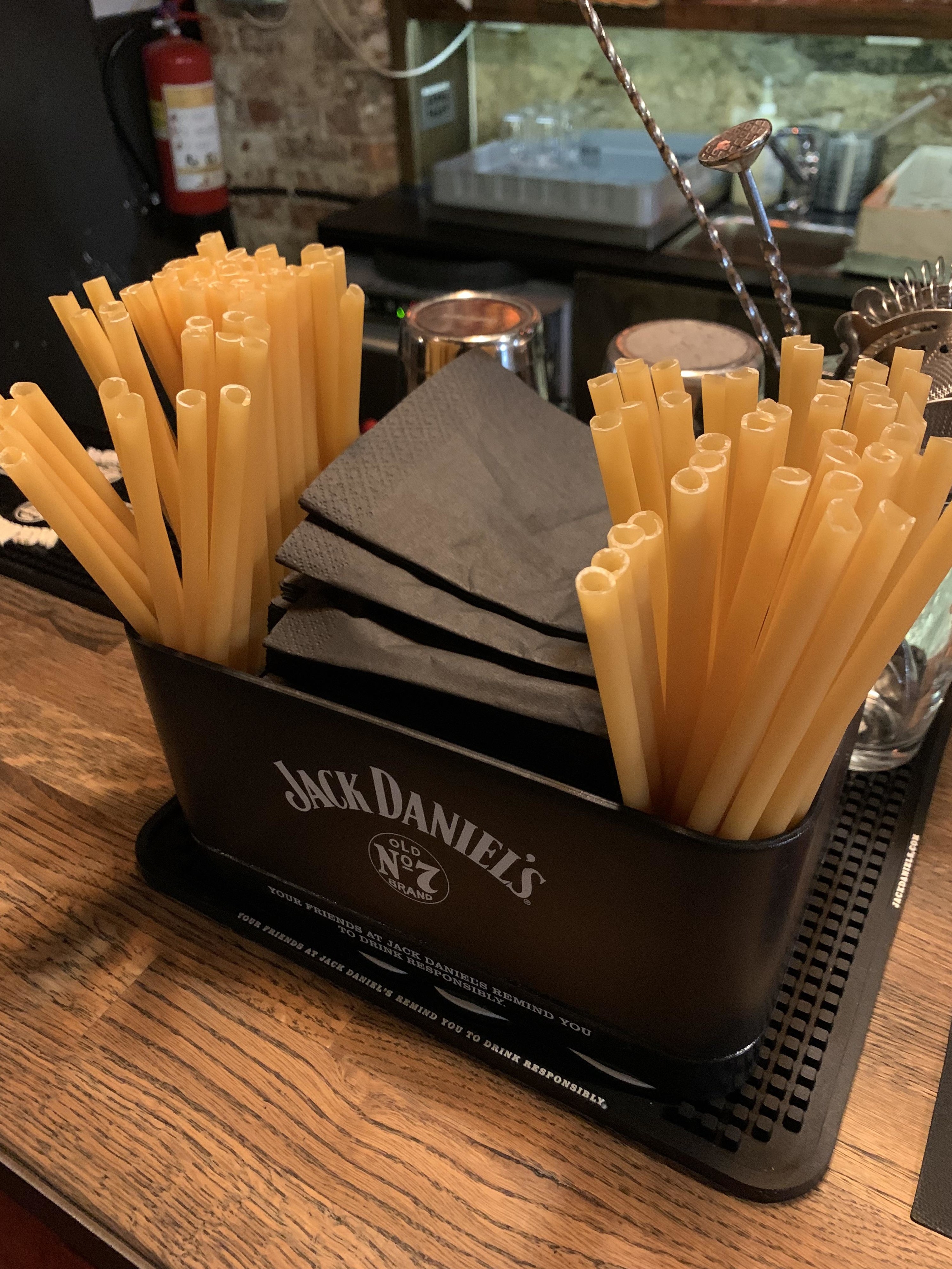 long tube shaped pasta in a caddy on a bar counter