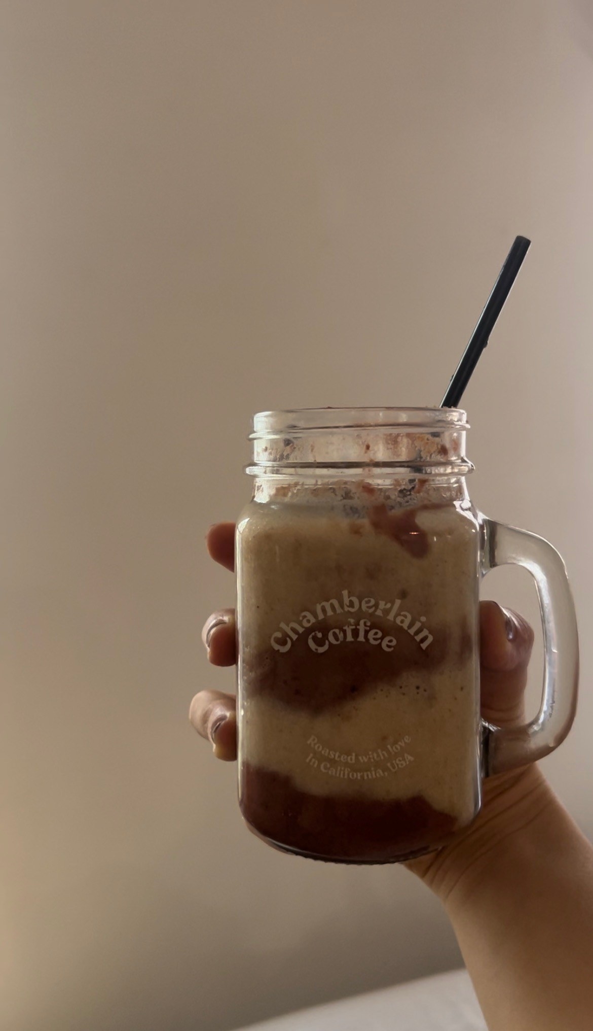 The author holds the smoothie in her hand