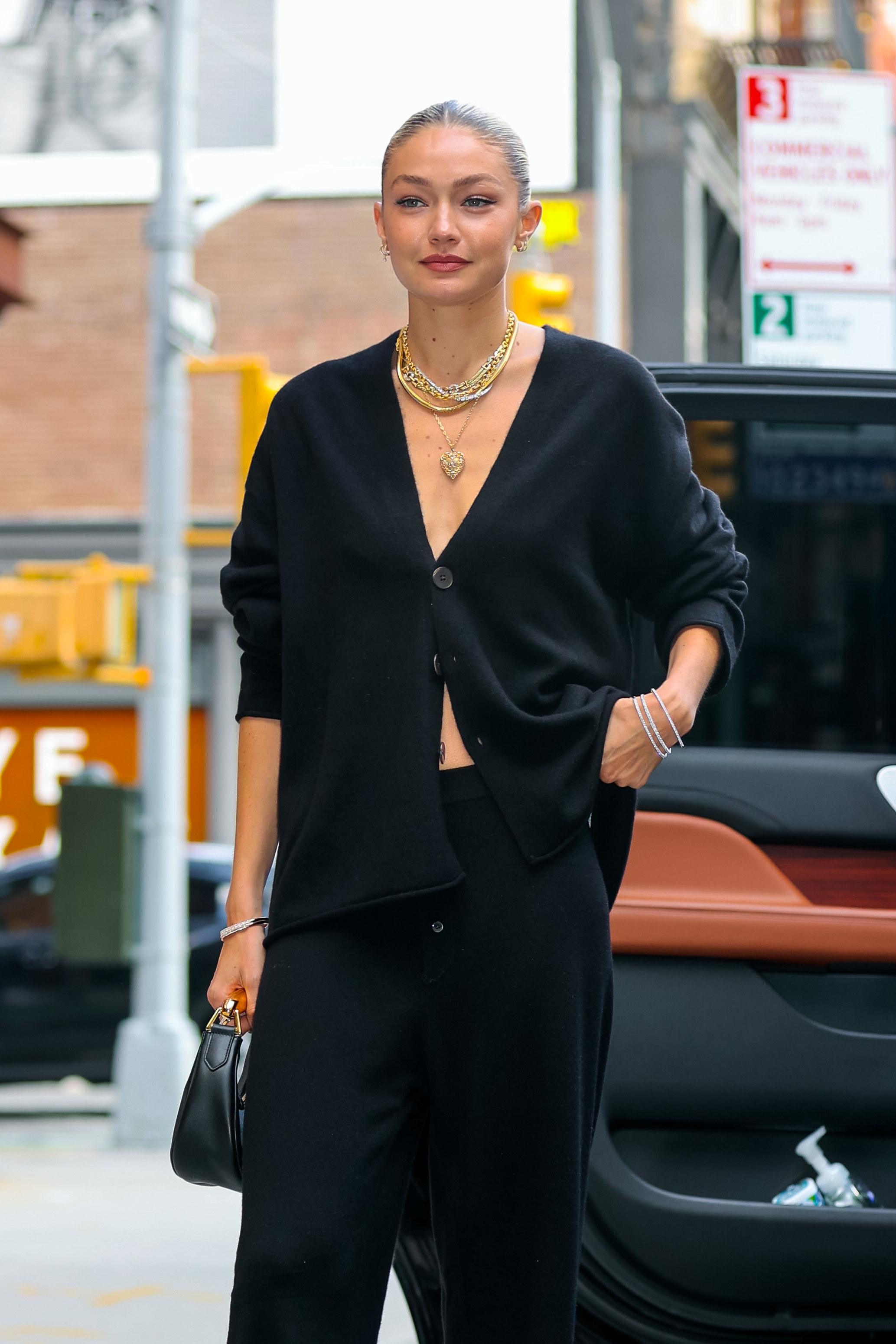 Close-up of Gigi in a loose cardigan and pants