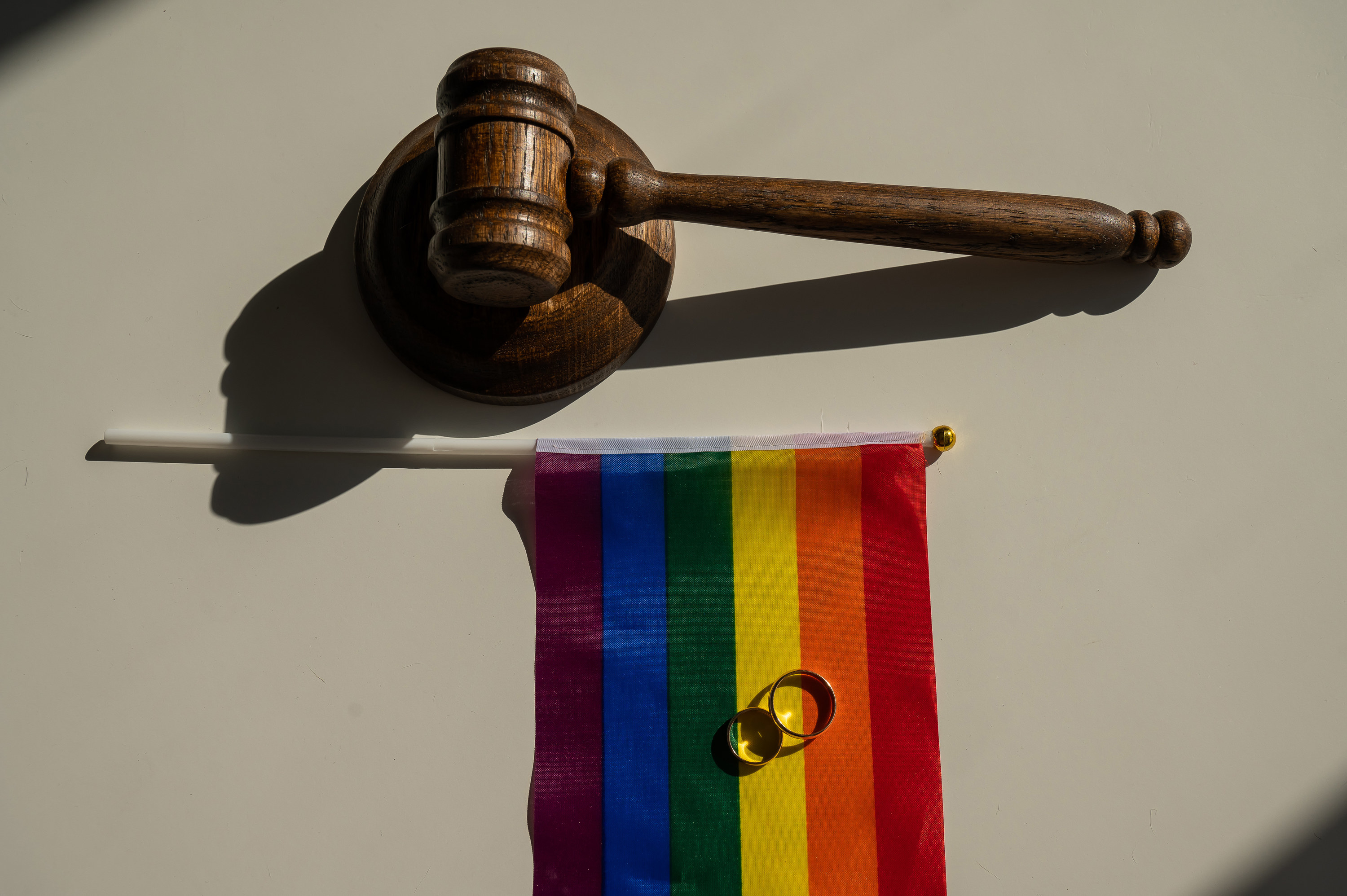 gavel and pride flag with rings