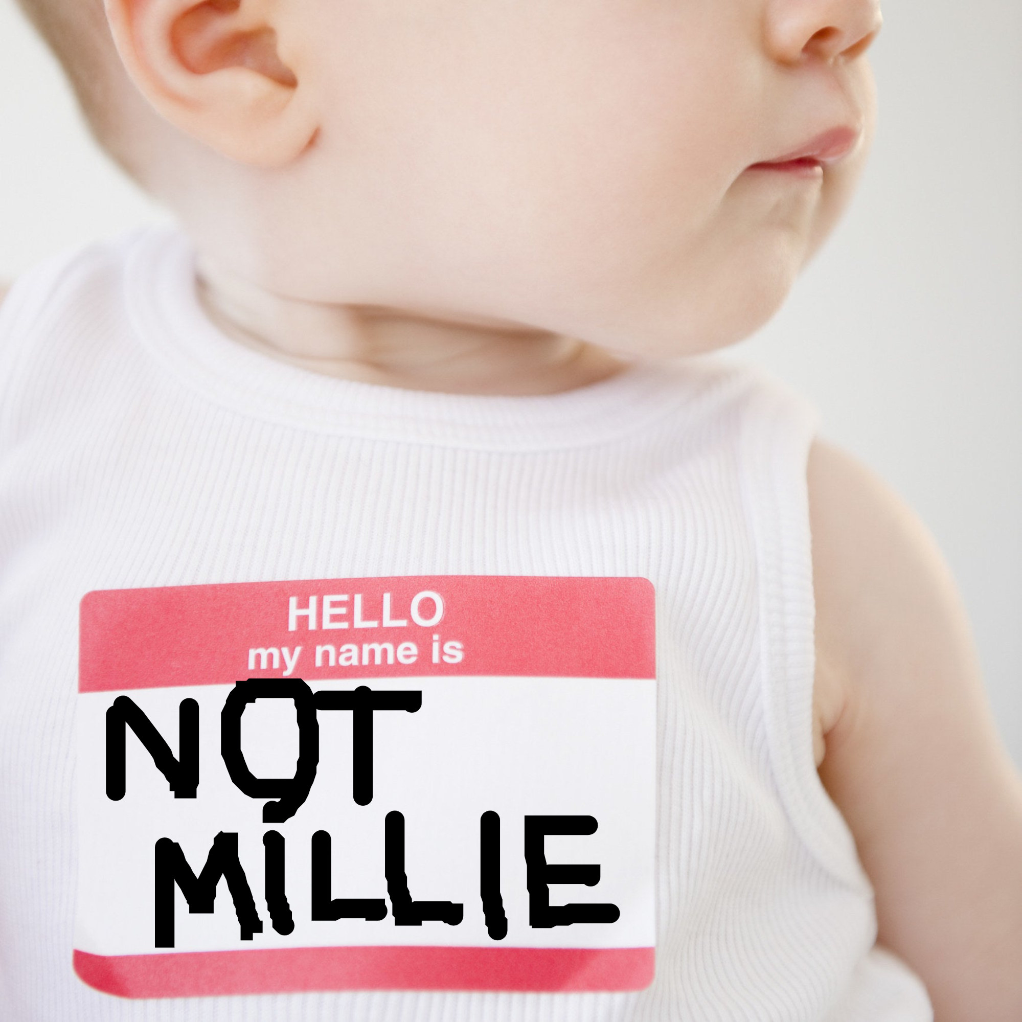 baby with a name tag that says not millie