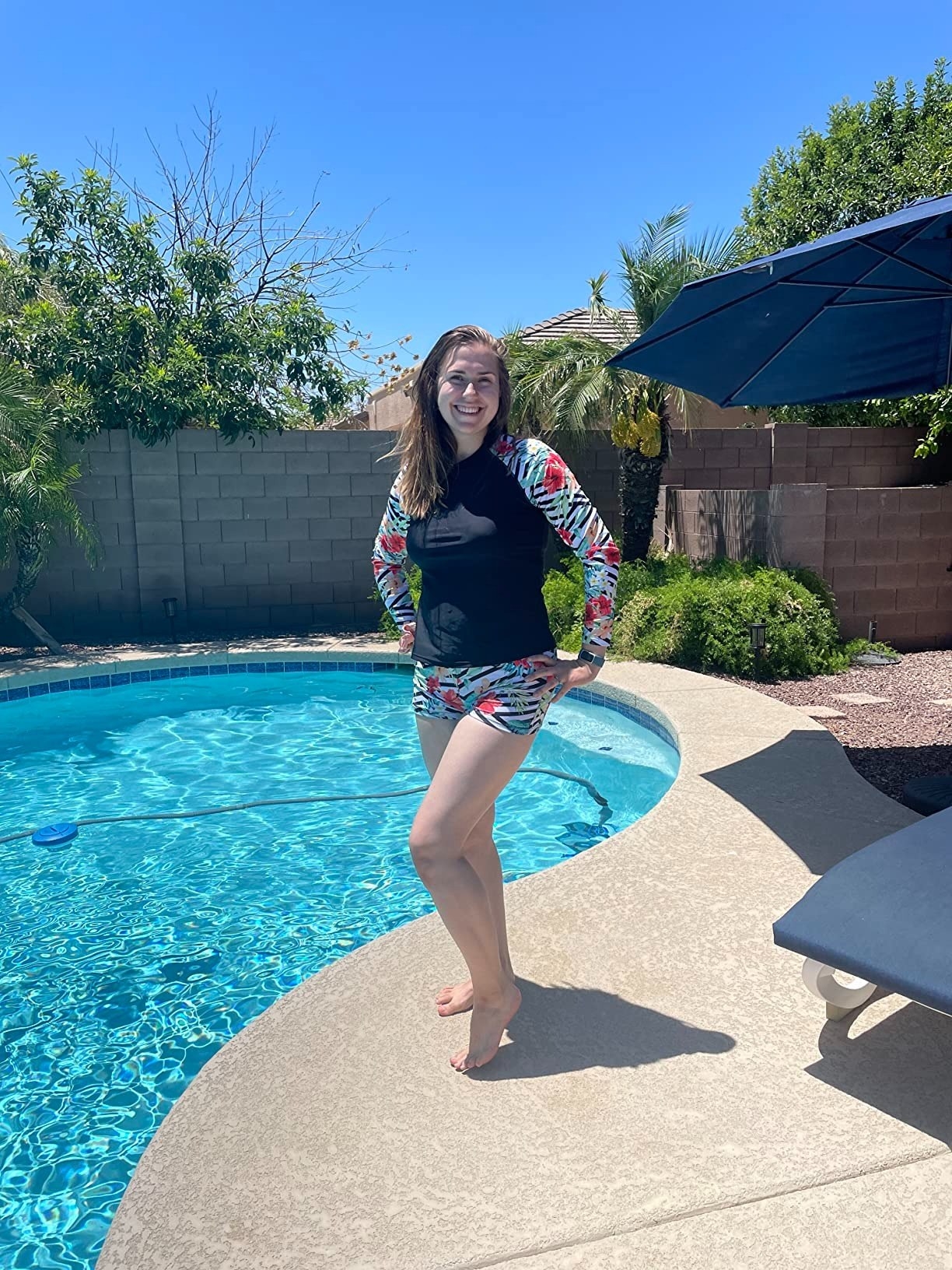 A reviewer in the rash guard and short bottoms