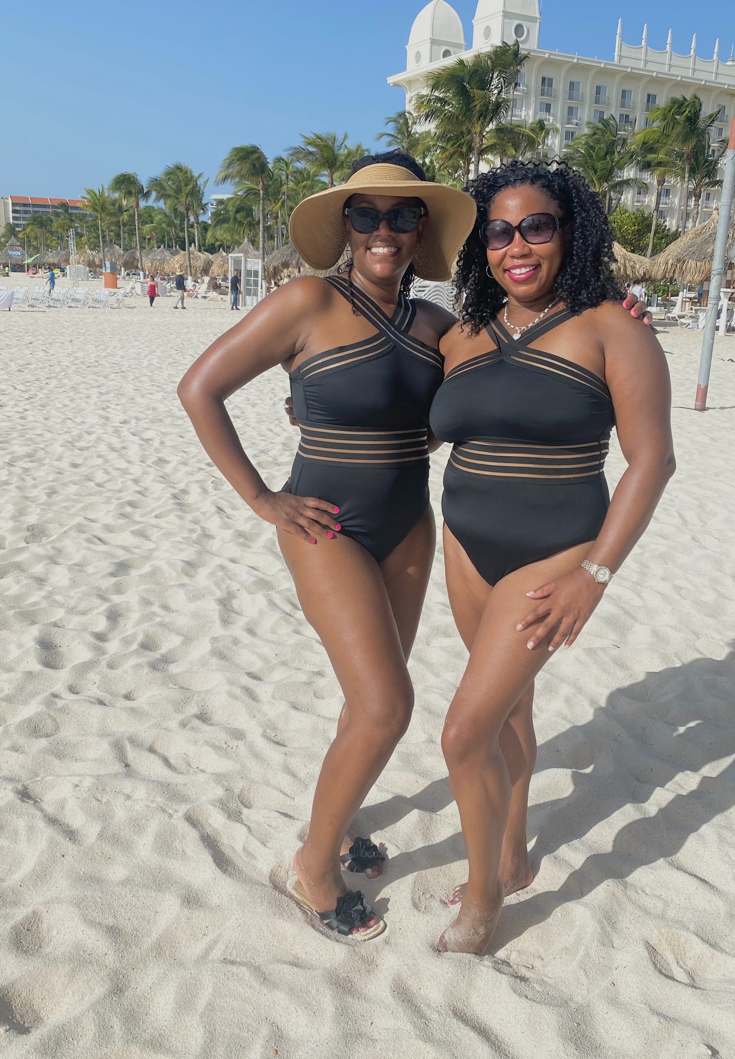 A reviewer and a friend wearing the black bathing suit