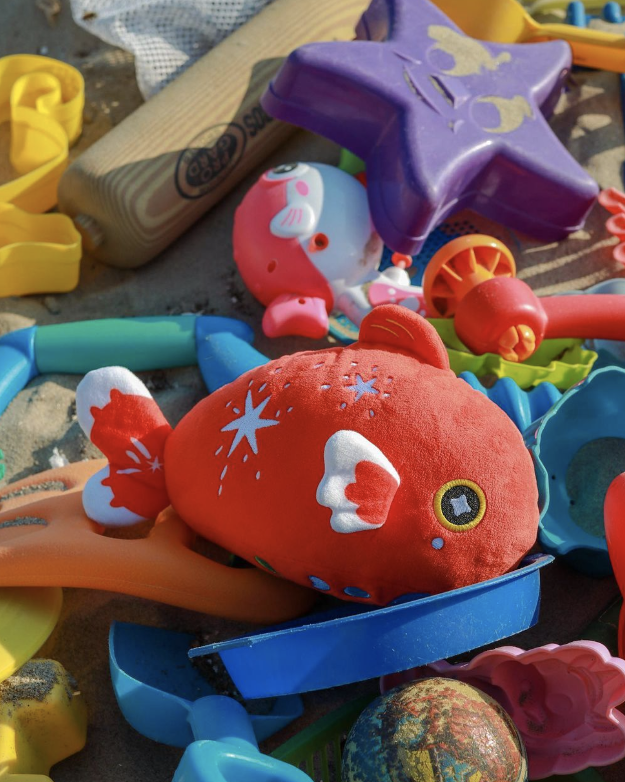 Starry Goldfish in a pile of other beach toys