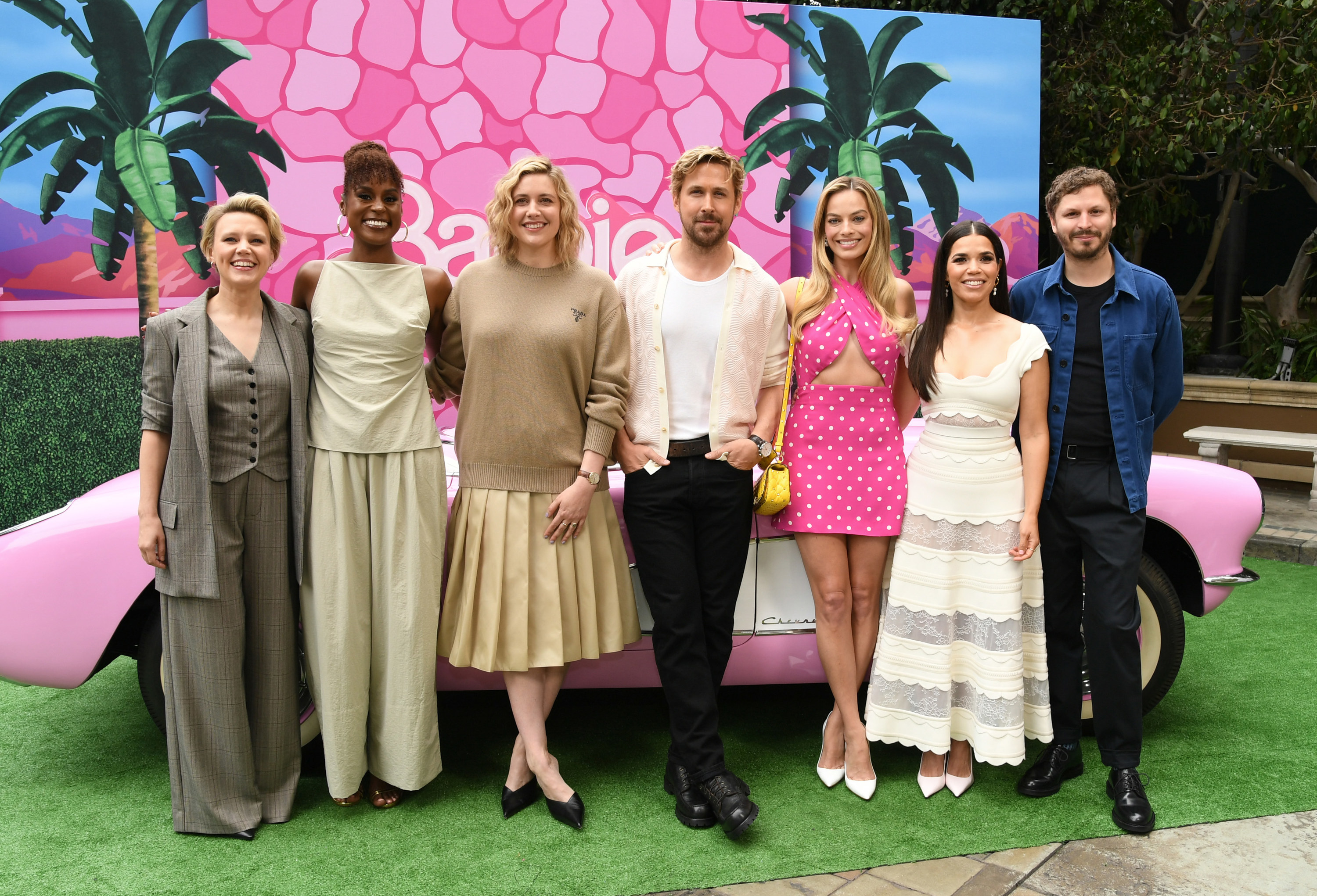 From left to right: Kate McKinnon, Issa Rae, Greta Gerwig, Ryan Gosling, Margot Robbie, America Ferrera, and Micahel Cera pose for a group photo in front of a pink convertible