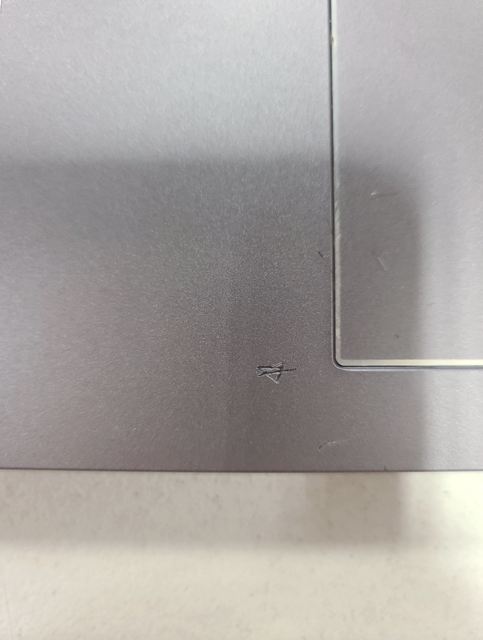 The surface has a triangle carved into it