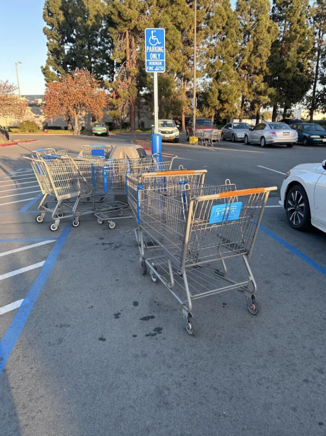 Handicapped parking spot blocked by a bunch of shopping carts