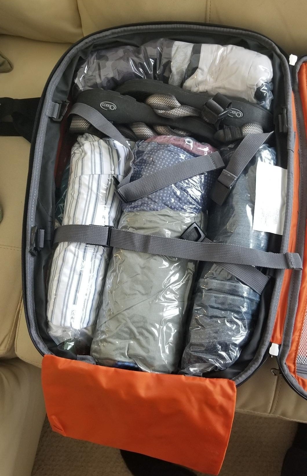 Reviewer&#x27;s photo of travel bags packed in a suitcase.