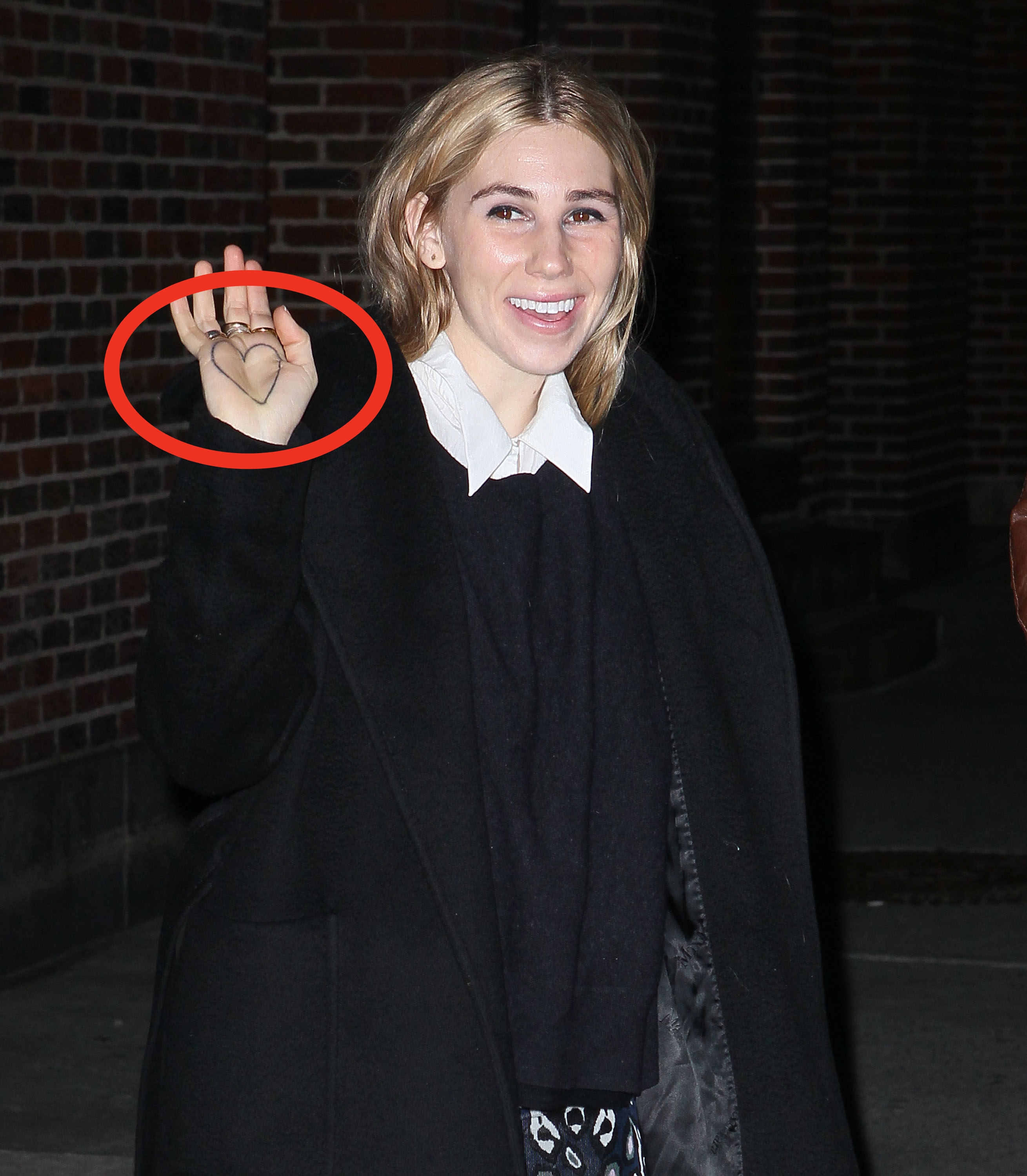 Closeup of Zosia Mamet and a circle over her hand tattoo