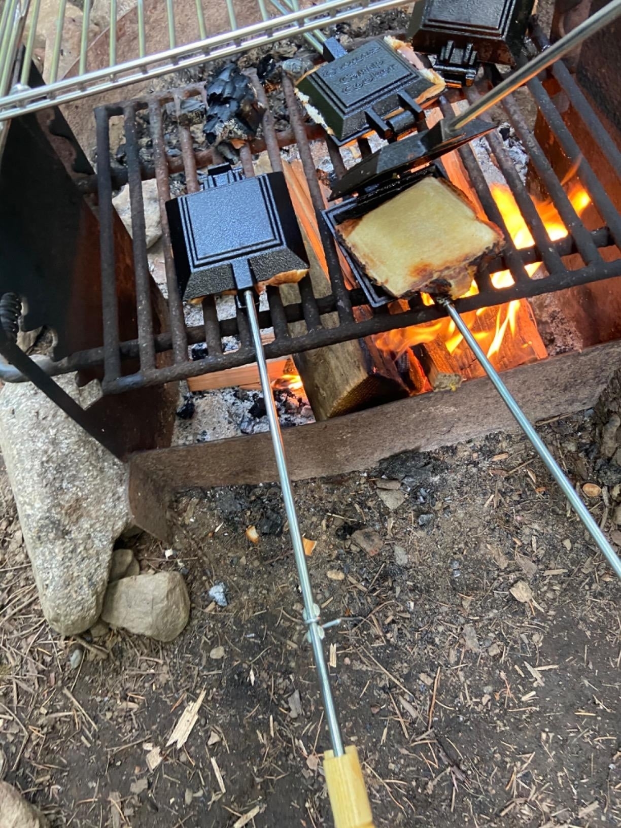 a reviewer using the griller inside a charcoal grill fire