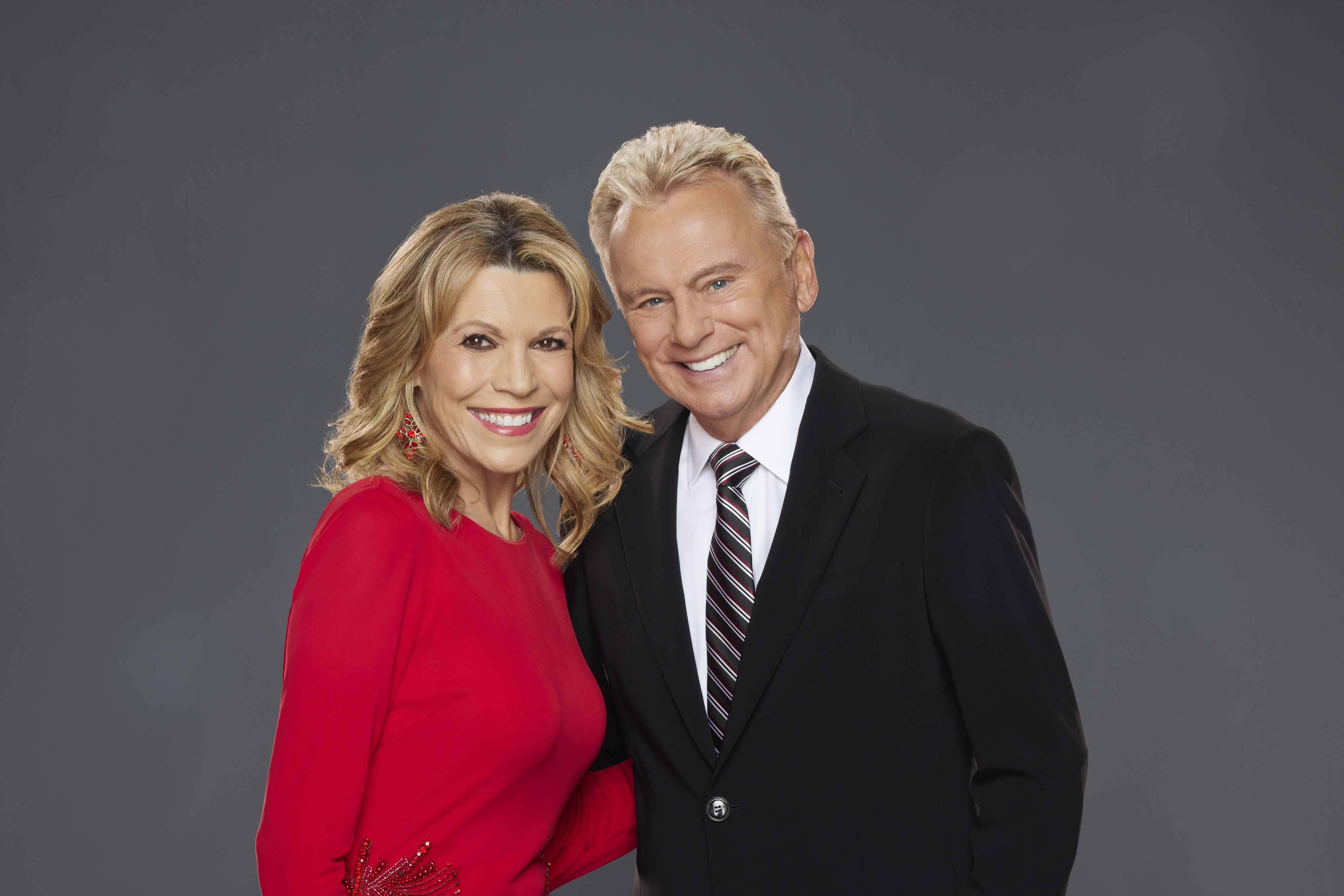 Pat and Vanna smile as they pose together for a promo photo