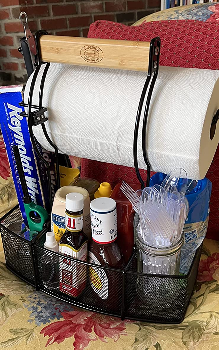 a reviewer photo of the caddy loaded up with a roll of paper towels and some condiment bottles