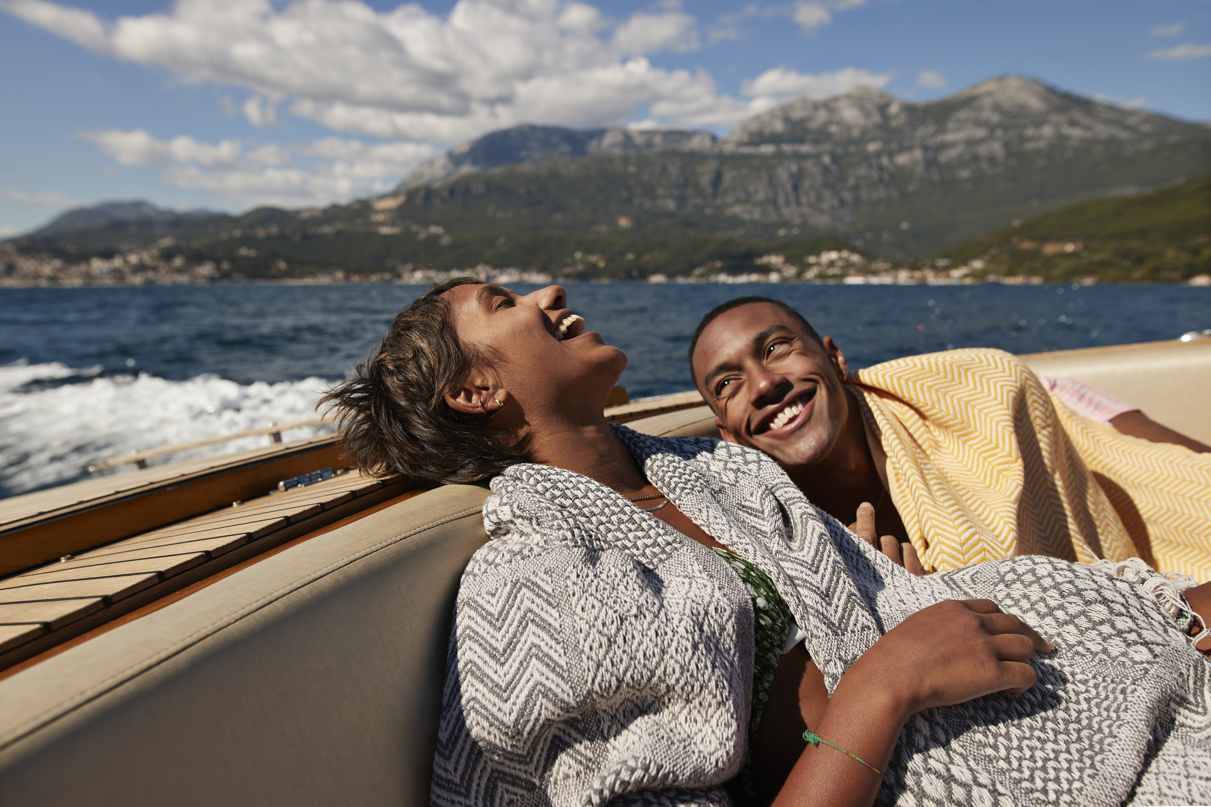 a man and a woman laughing in a boat