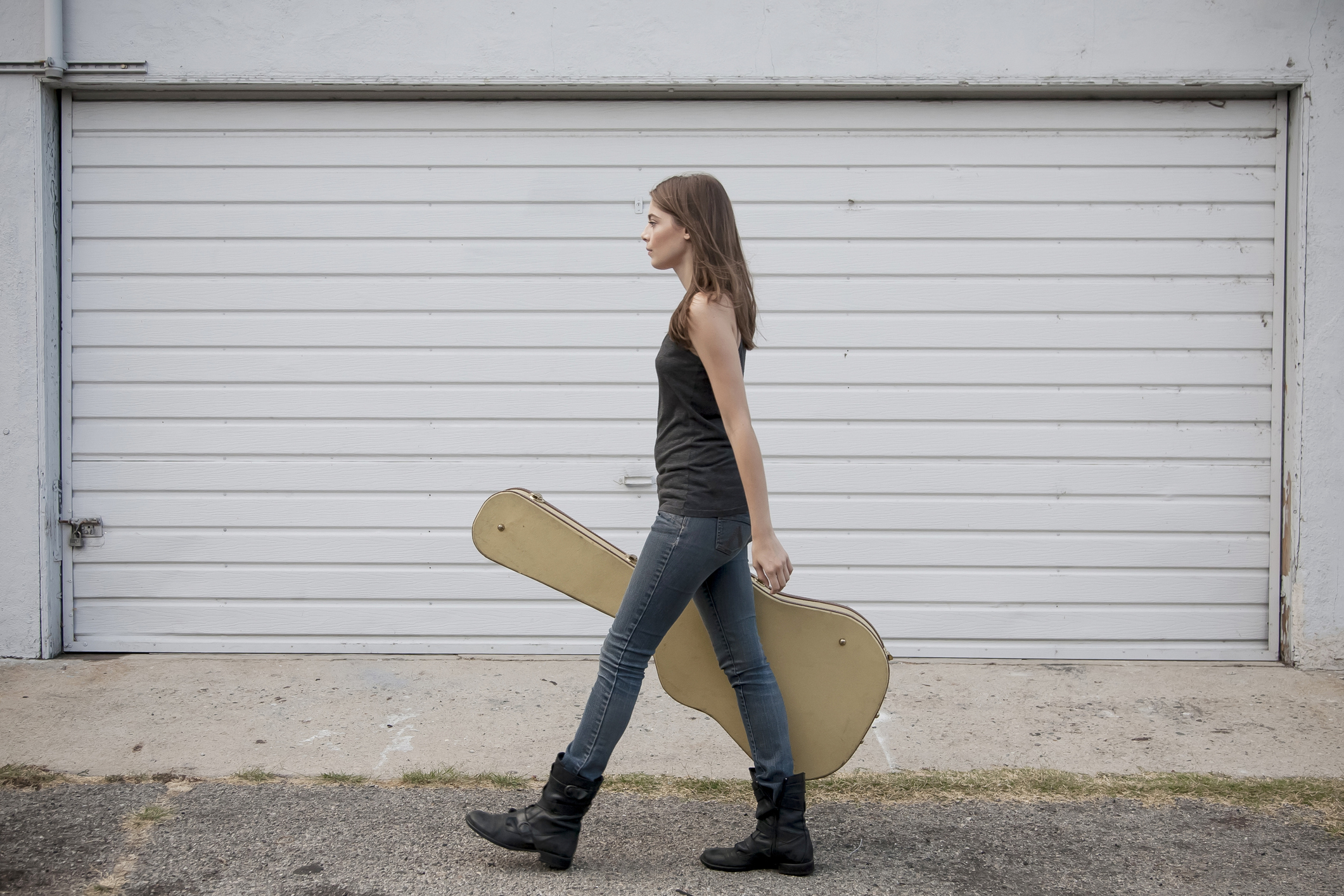 Woman carrying guitar on the street