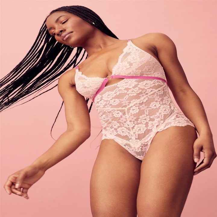 model wearing pink lace bodysuit