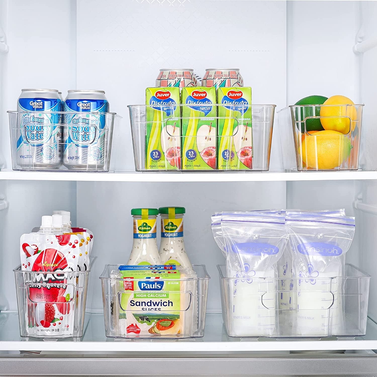 Storage bins with food inside a refrigerator.