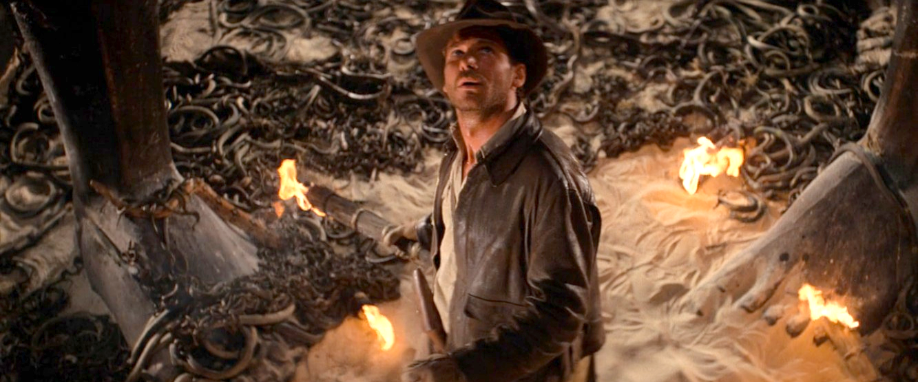 Indy holding a torch surrounded by snakes