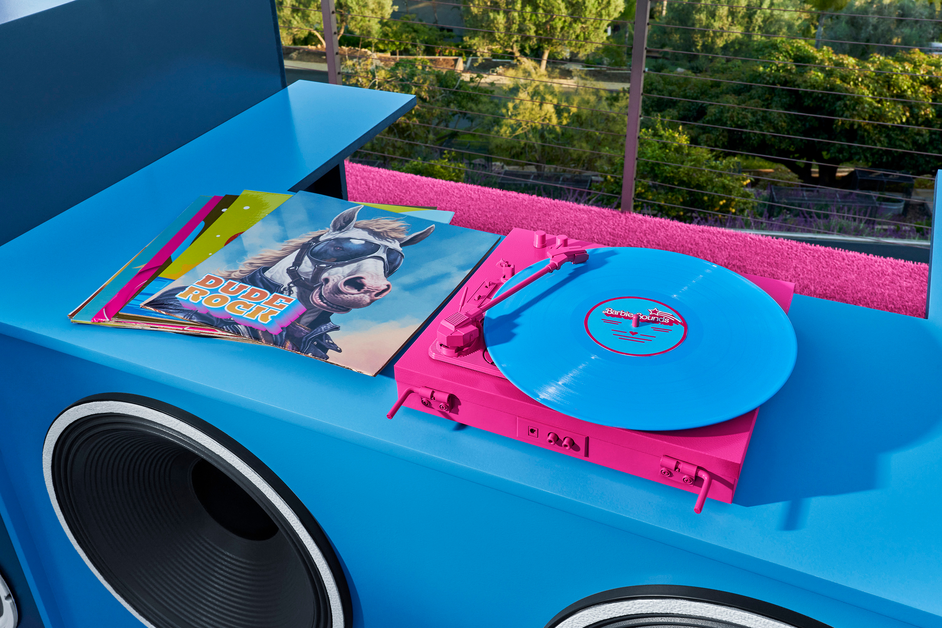 A closeup of a neon pink vinyl record player