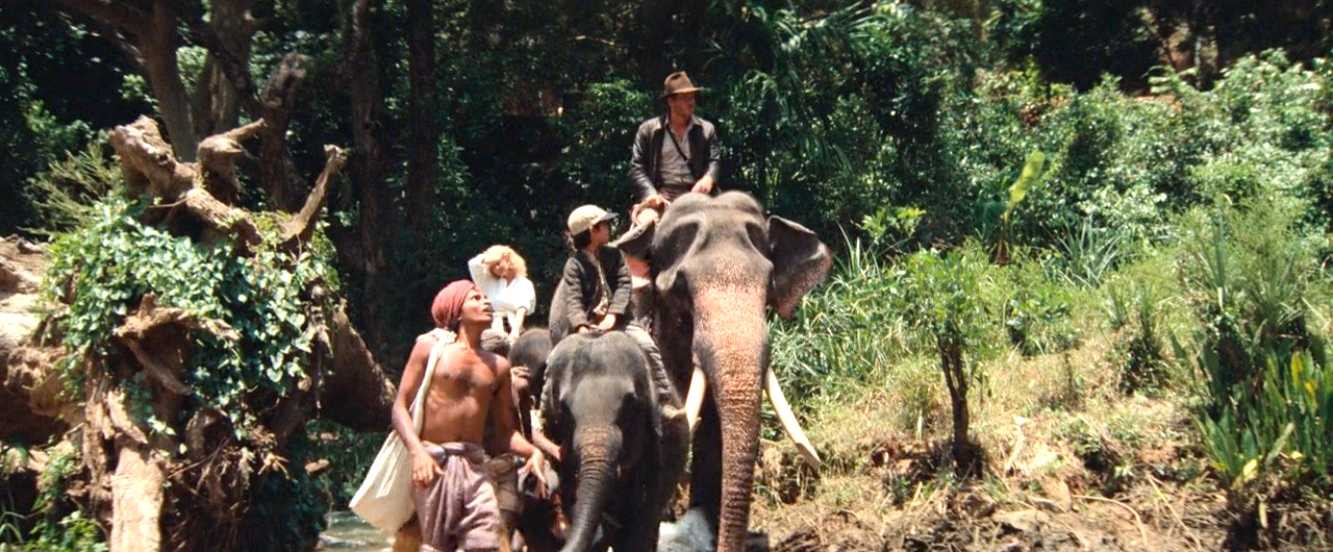 Indy, Short Round, and Willie riding elephants through the jungle