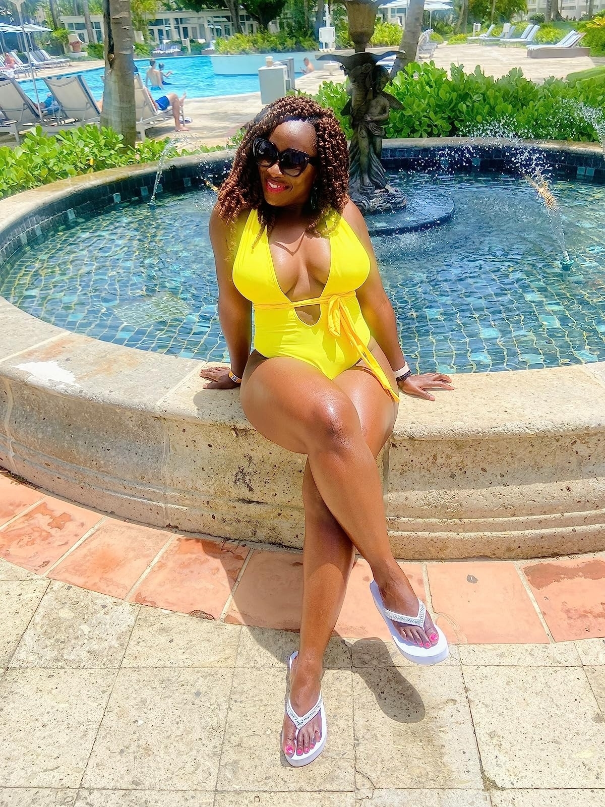 reviewer wearing the plunge front swimsuit in a yellow color