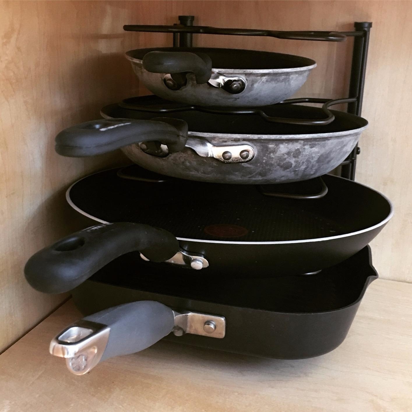 Reviewer&#x27;s photo of pans stored in a pan organizer.