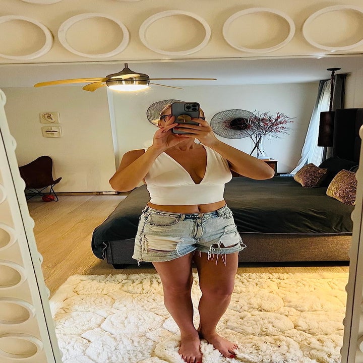 front view of a reviewer wearing the top in white