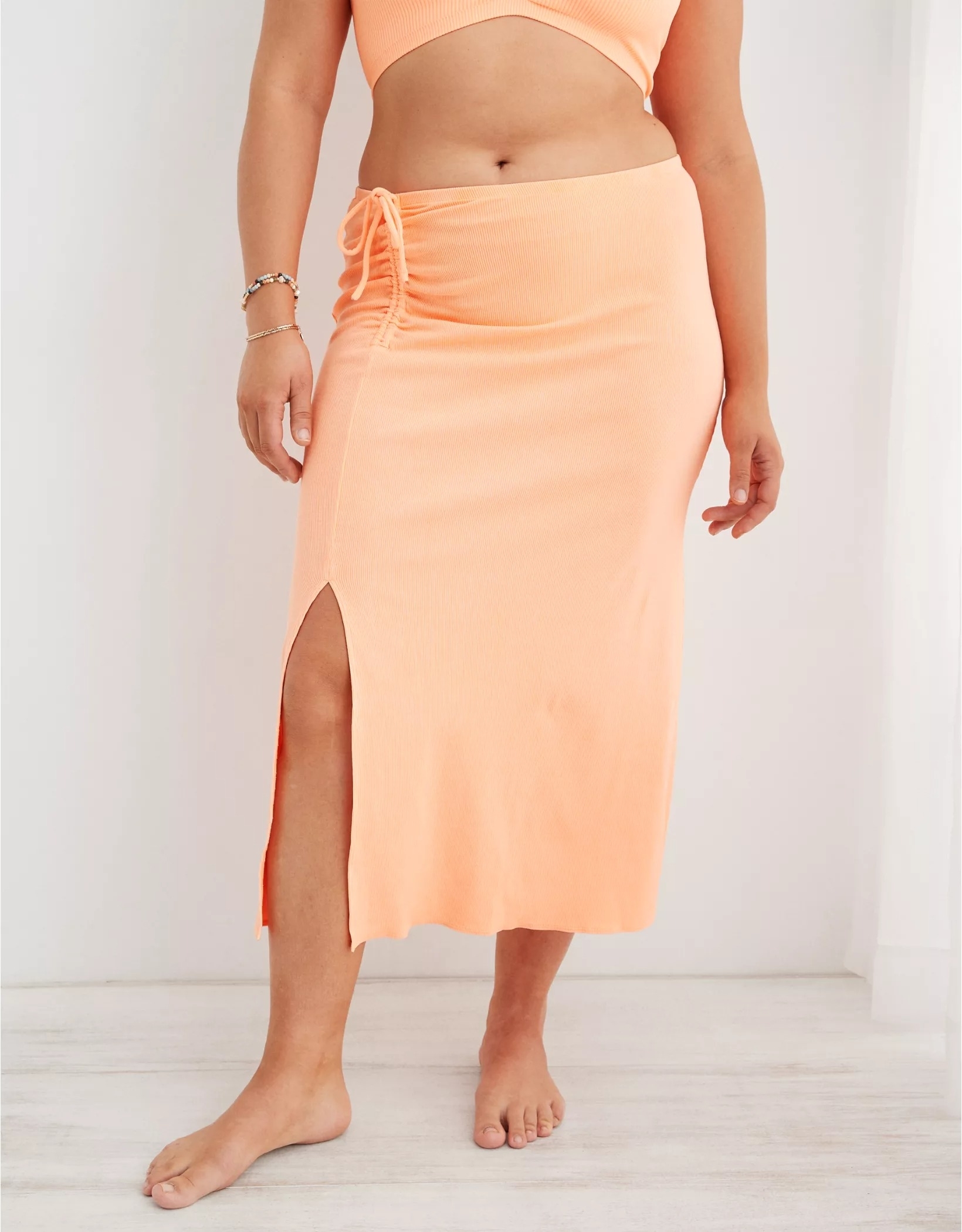 Model wearing midi skirt in peach