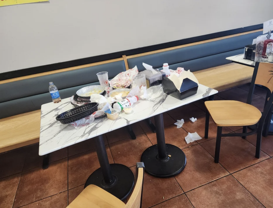 Food left all over a restaurant table