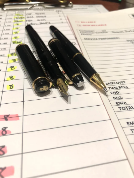 pens set atop carbon copy paper