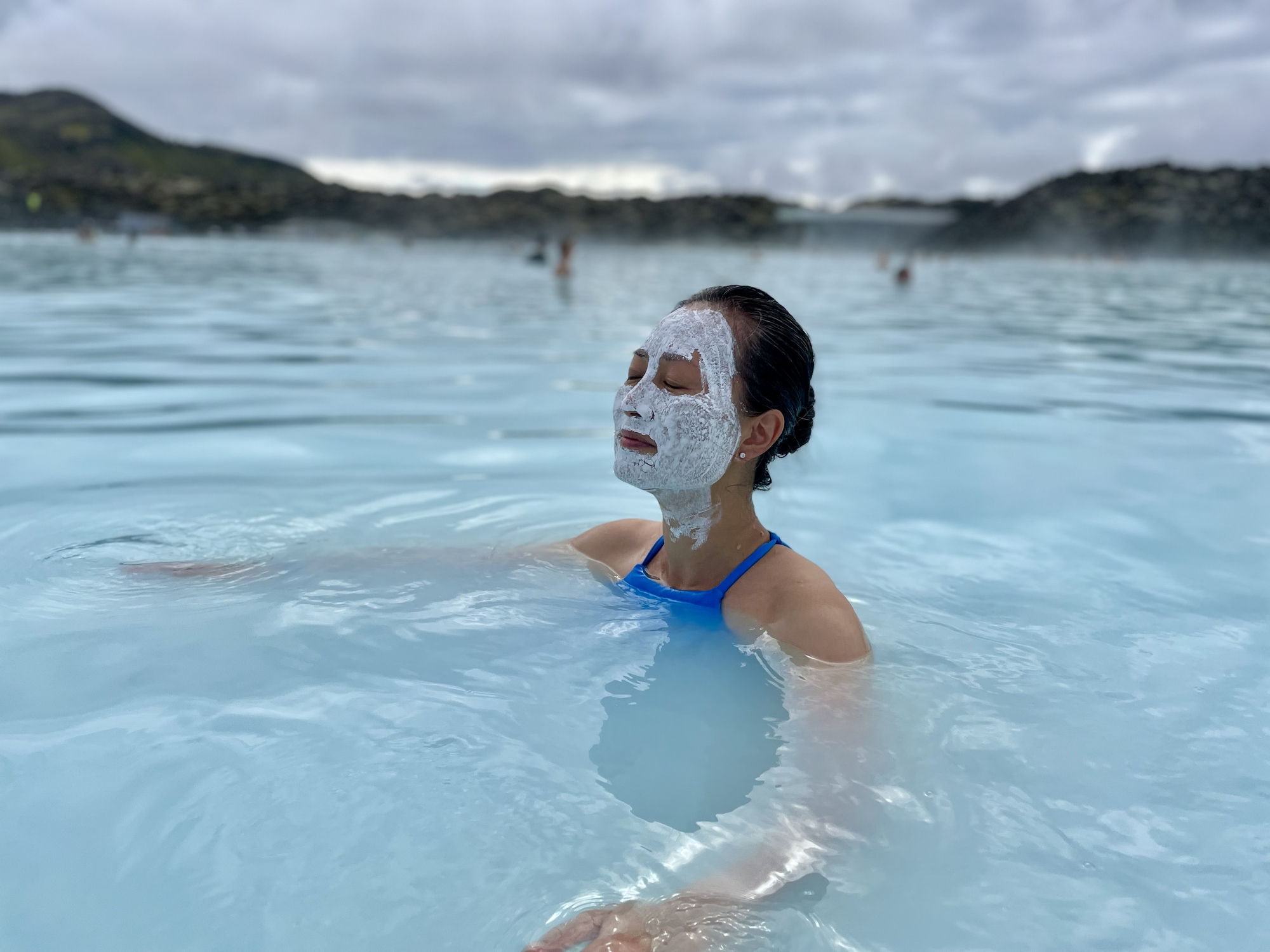 A woman wearing face cream in the lagoon