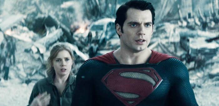 Henry Cavill as Superman with Amy Adams as Lois behind him
