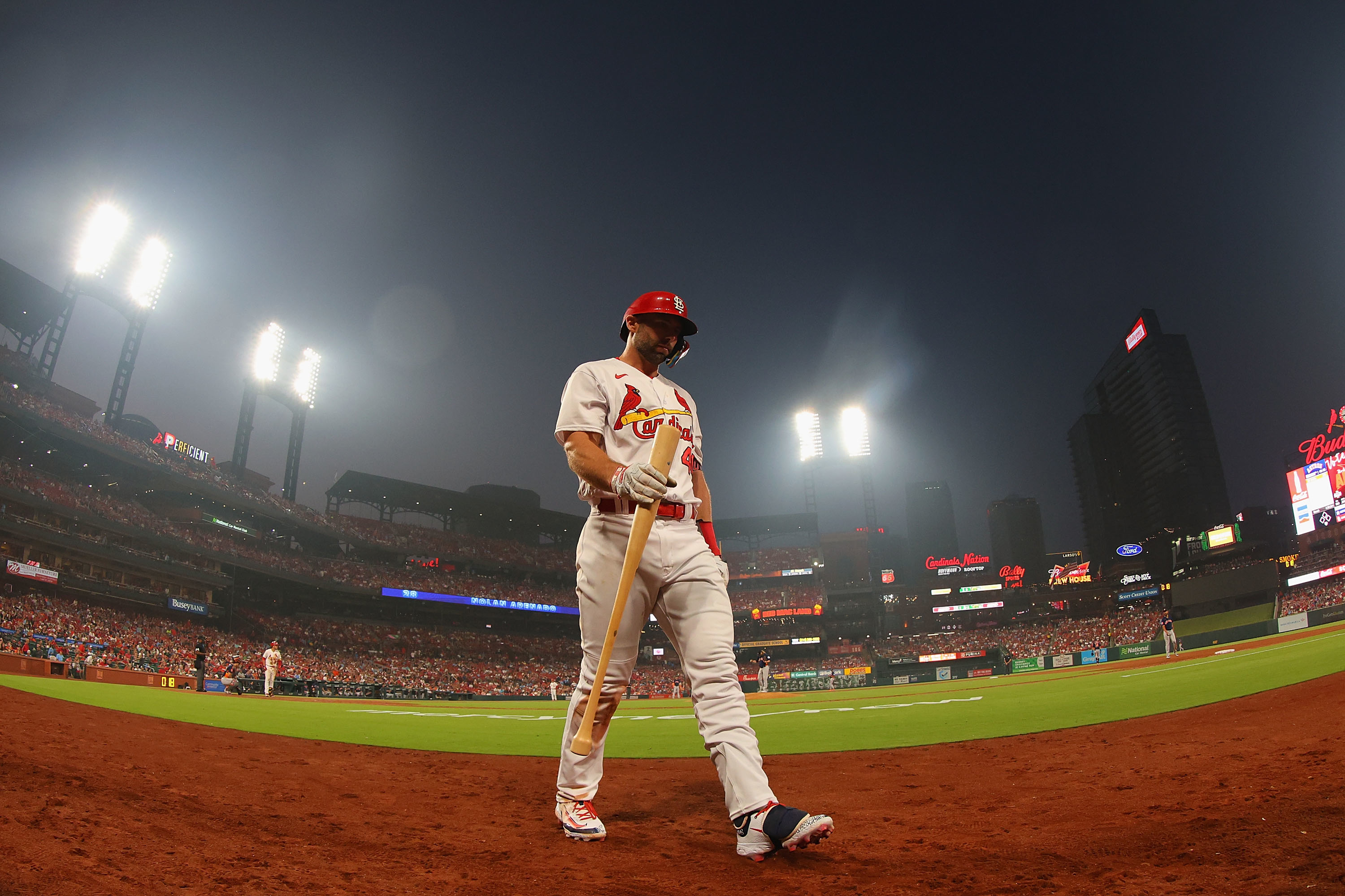 A member of the St. Louis Cardinals walking off the field under the lights