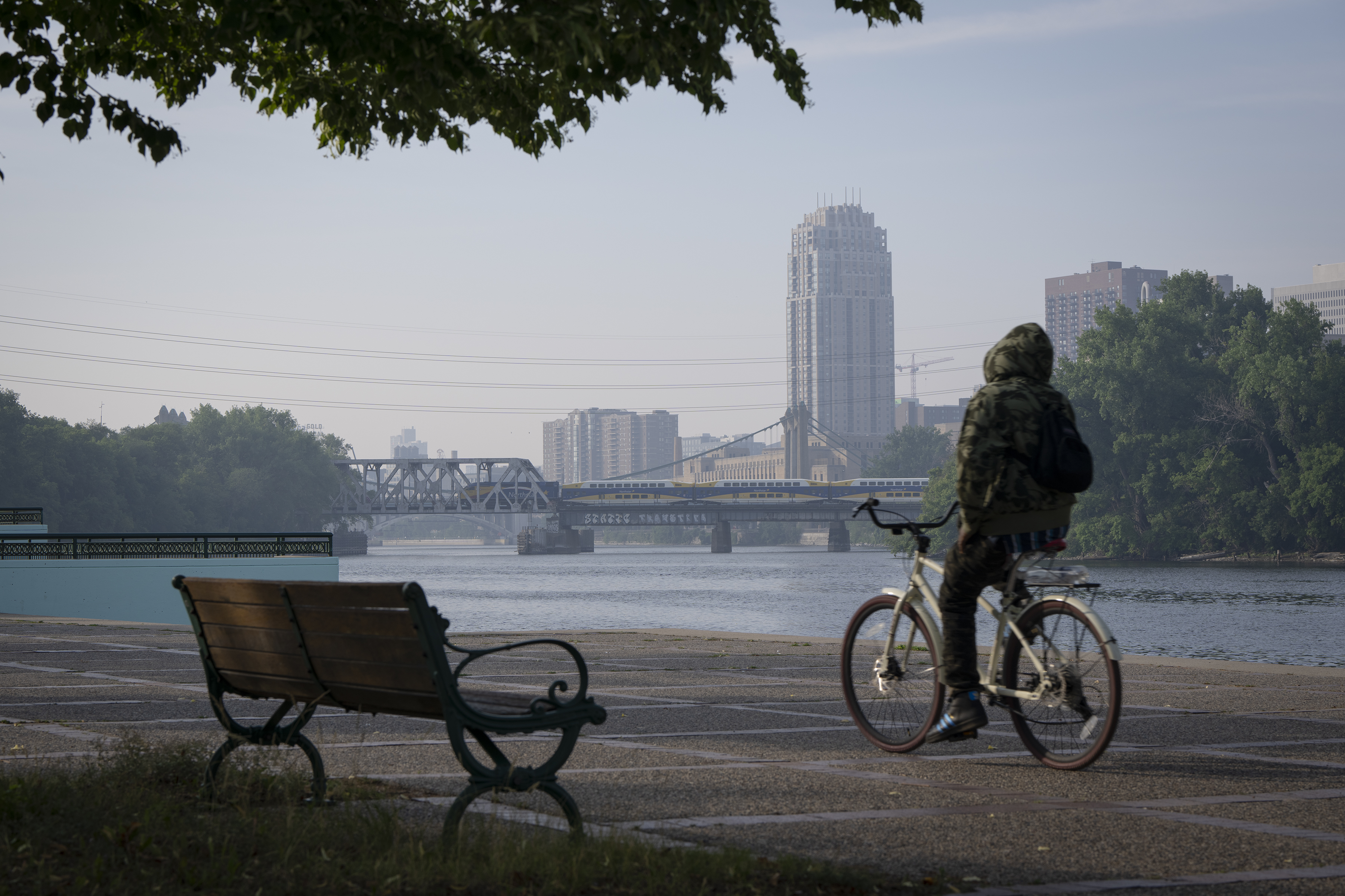 A person on their bicycle cycling by the river